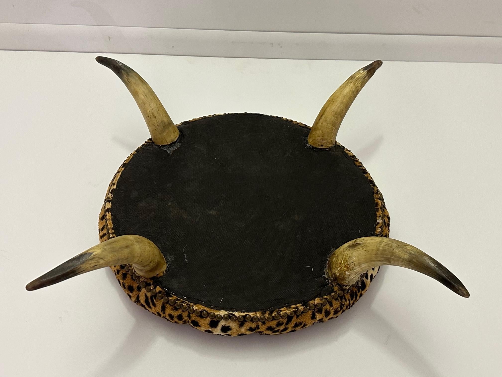 Sensational Anique Round Tufted Faux Leopard Stool with Horn Legs 1
