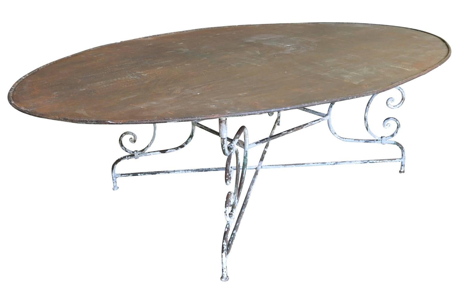 A terrific early 20th century oval garden table, dining table in painted iron. Great for any interior or exterior.