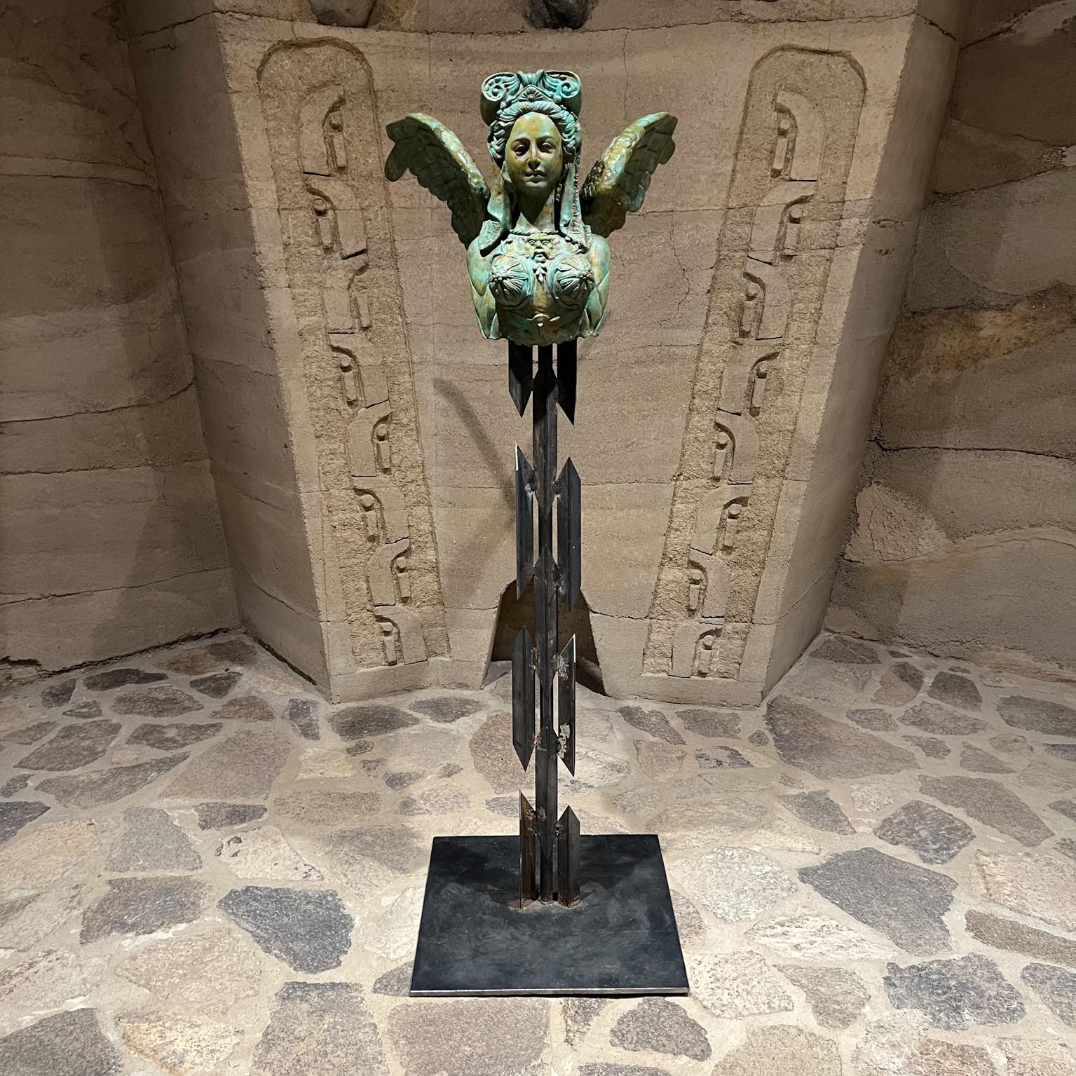 Greek mythology Sphinx imagery Bronze Sculpture female lion bust with wings
61.5 tall x 24.5 w x 34 d
Mounted on forged steel base.
Unsigned.
Original vintage condition. Verdigris patina.
Two more are available with different patination.
Consult