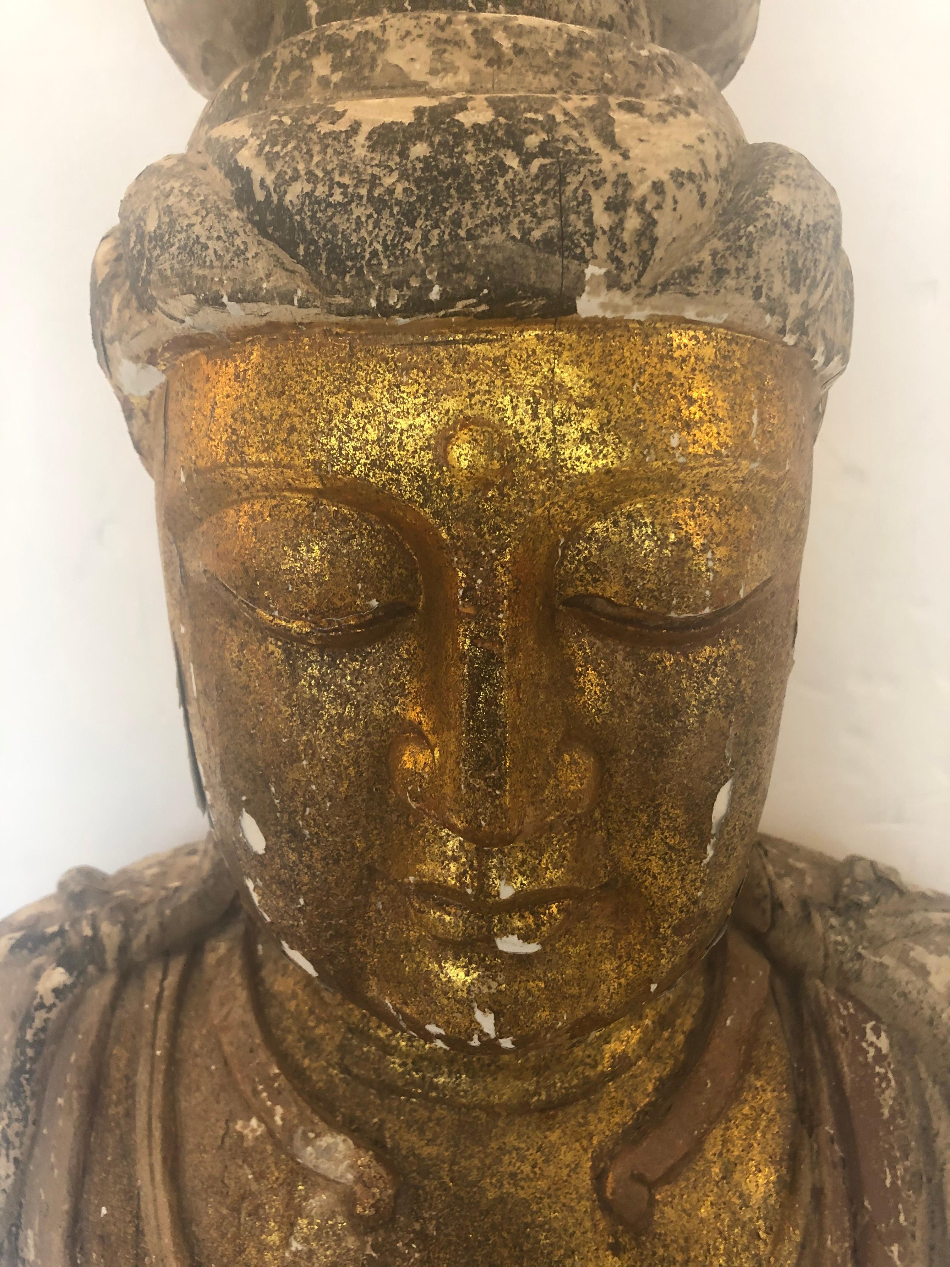 Super dramatic very large carved wood and gilded seated Buddha having fantastic distressed patina and gorgeous gestural hands.