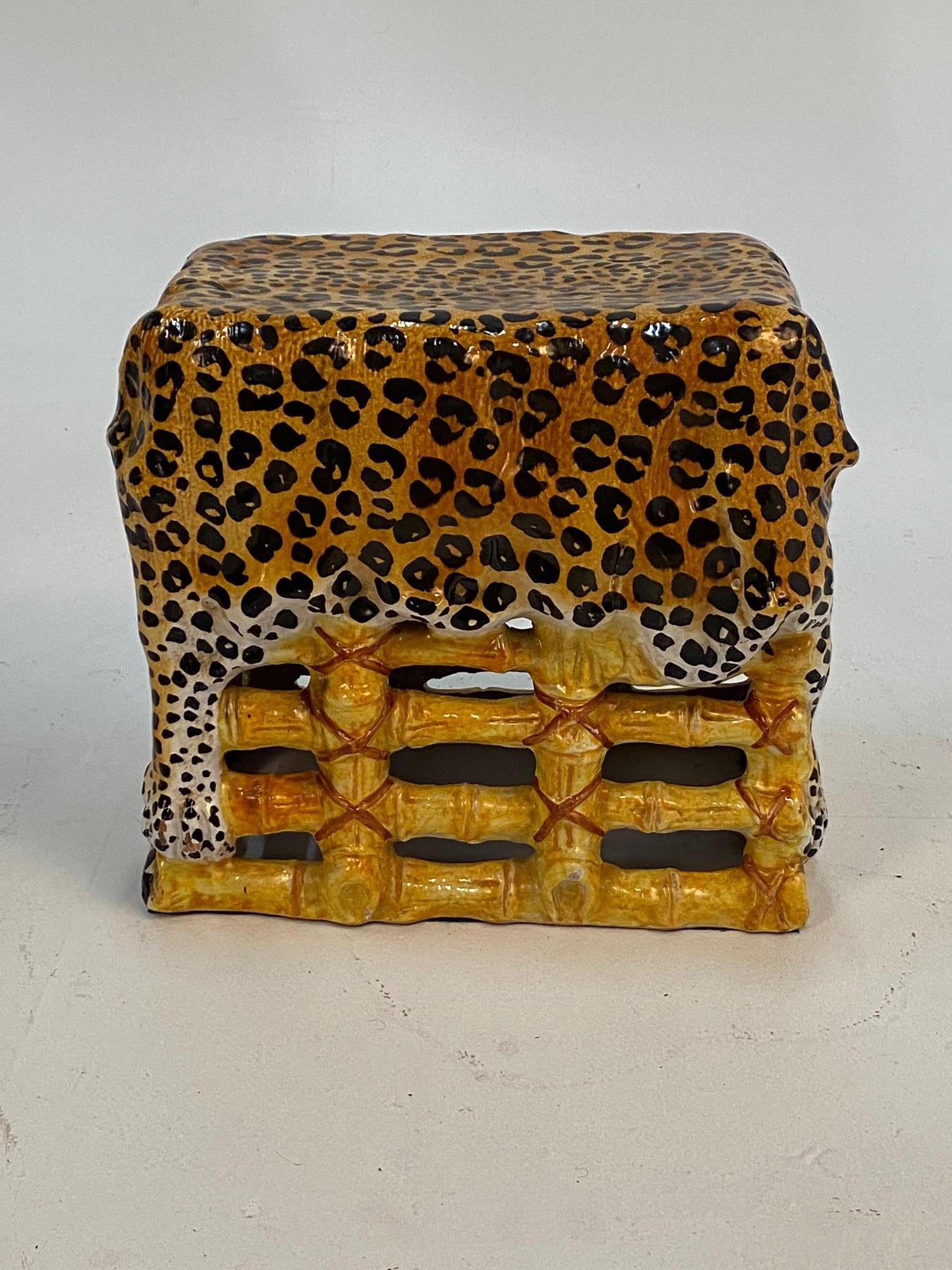 An unusual glamorous form of an Italian terracotta garden seat and table having leopard print draped over bamboo-esque base. Colors are warm gold and black, very striking.
