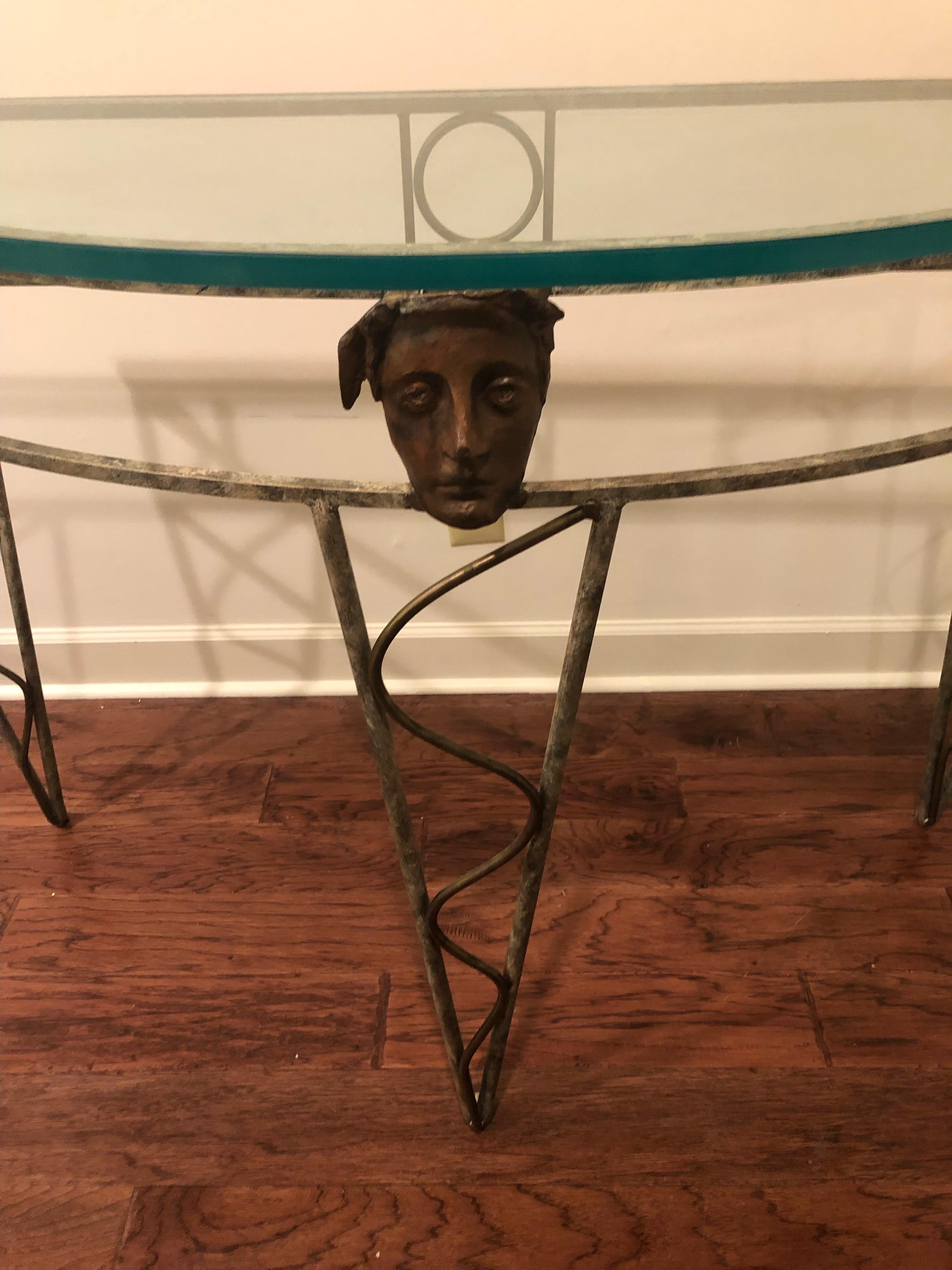 A stunning demilune iron and glass console table by Nicaraguan artist Mario Villa, known for imaginative distinctiive furniture, jewelry, and paintings, and his own gallery in New Orleans. He died last year. Many celebrities collected his work,