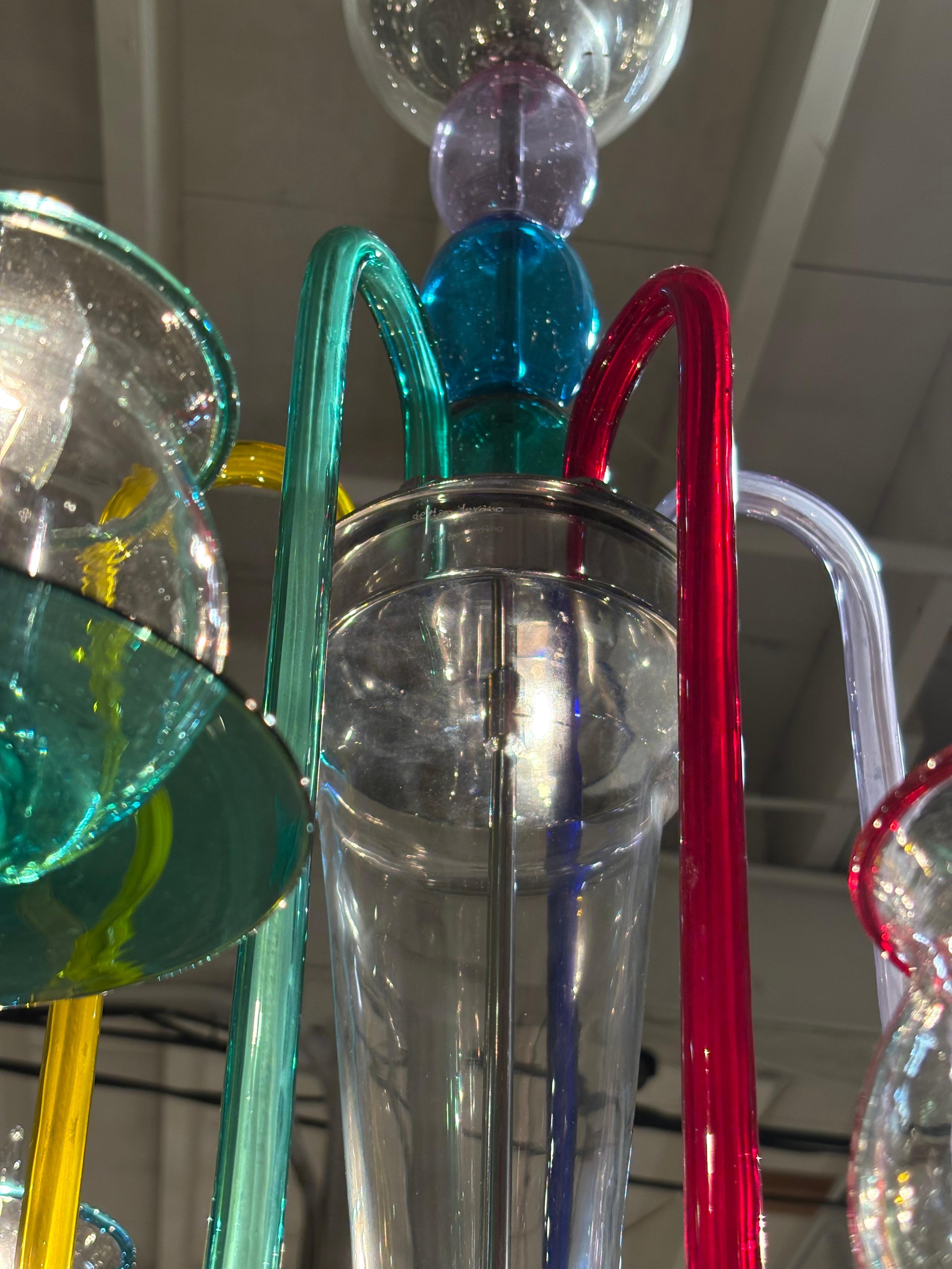 Chic multil colored Murano glass chandelier designed by De Majo.

De Majo is a renowned glassmaking company based in Murano, Italy, with a history dating back to 1947.
The company is known for its high-quality craftsmanship and innovative designs,