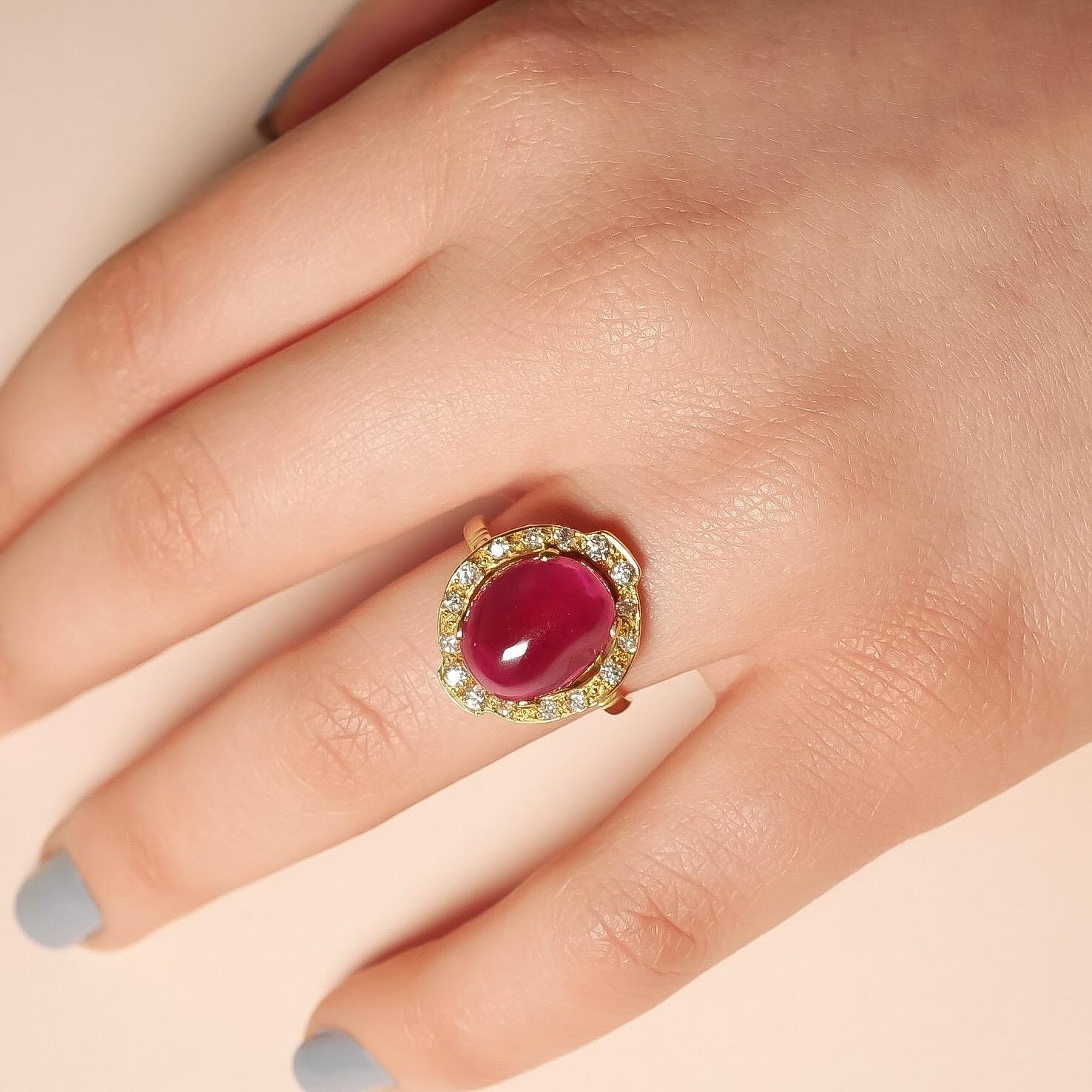 The centre stone in this one-of-a-kind yellow gold ring is a sublime pinkish red ruby cabochon, specially selected from the Haruni vault. Full of passion and spirit, the ruby is surrounded by a glittering white diamond halo, arranged octagonally