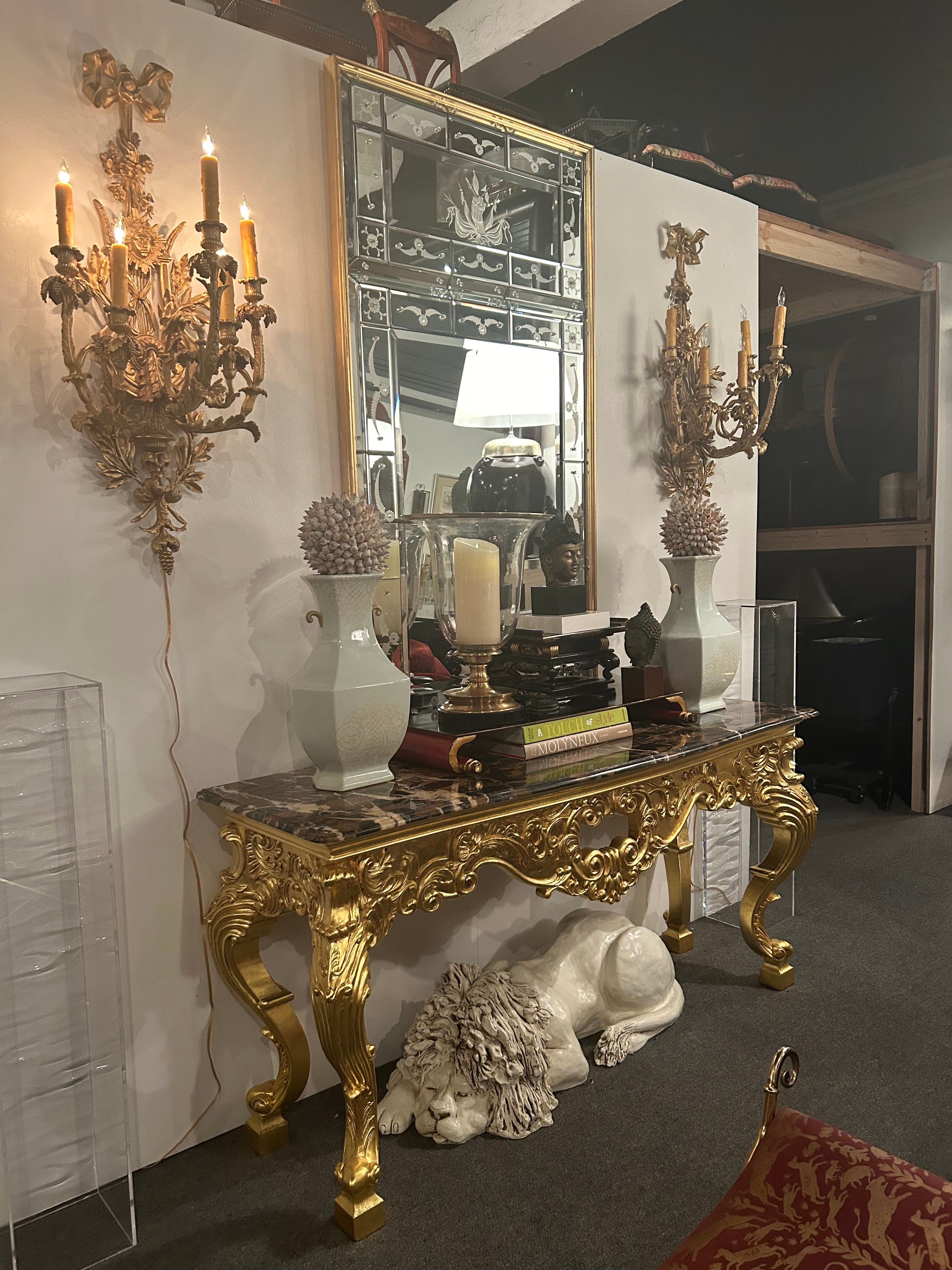 Absolutely gorgeous glamorous Venetian mirror having a rare design with beveled etched pieces of mirror fitted into a rectangular form with lovely cartouche decoration and gilt wood frame.  
