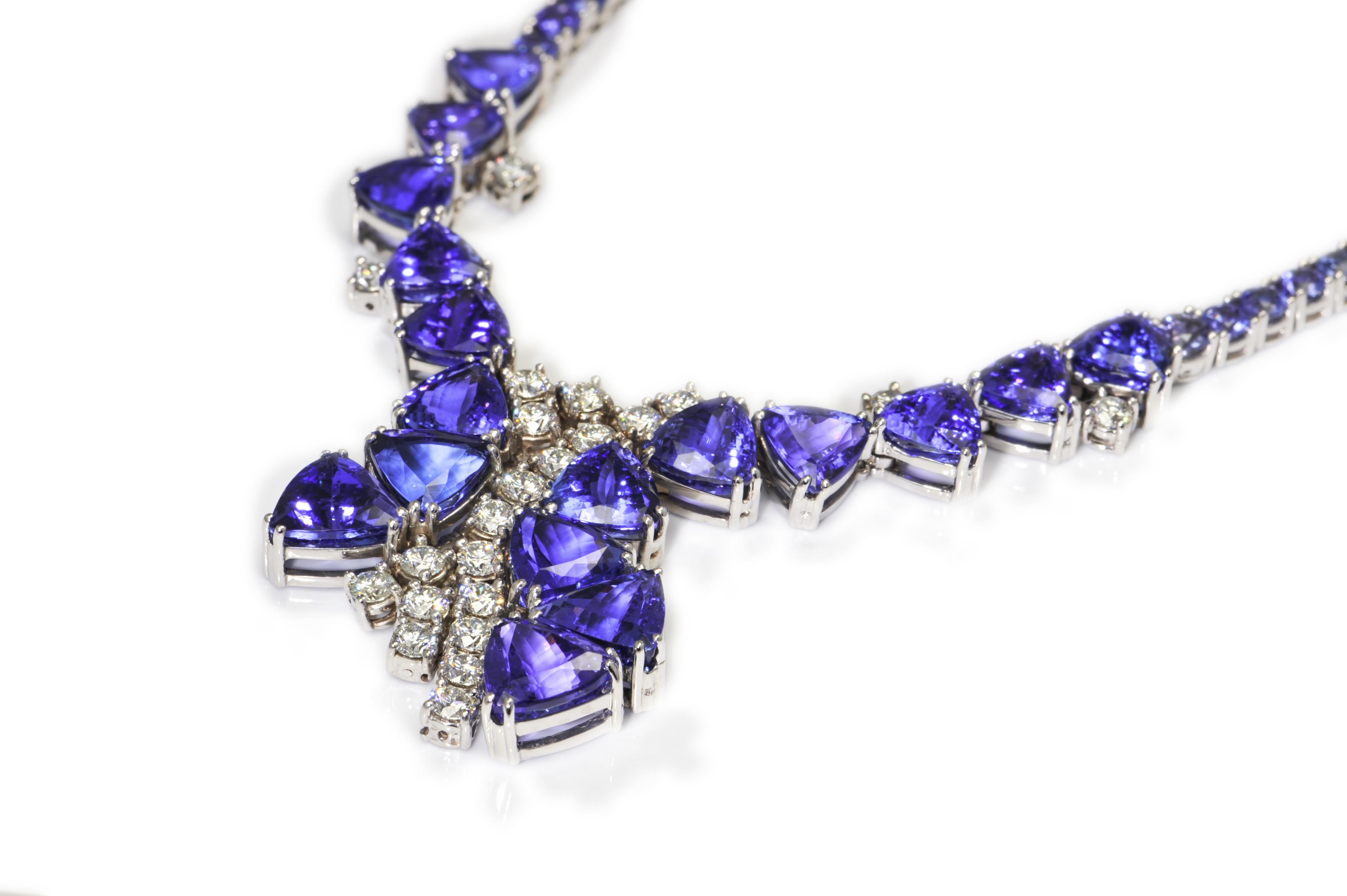 Simply Beautiful Tanzanite Burst and Diamond 18K White Gold Necklace, features 17 triangular Tanzanite 66.66tcw, 89 round cut Tanzanite 18.54 tcw and 22 Brilliant cut Diamonds 5.16tcw. Hand crafted in 18 Karat White Gold. Hand crafted and Hand set