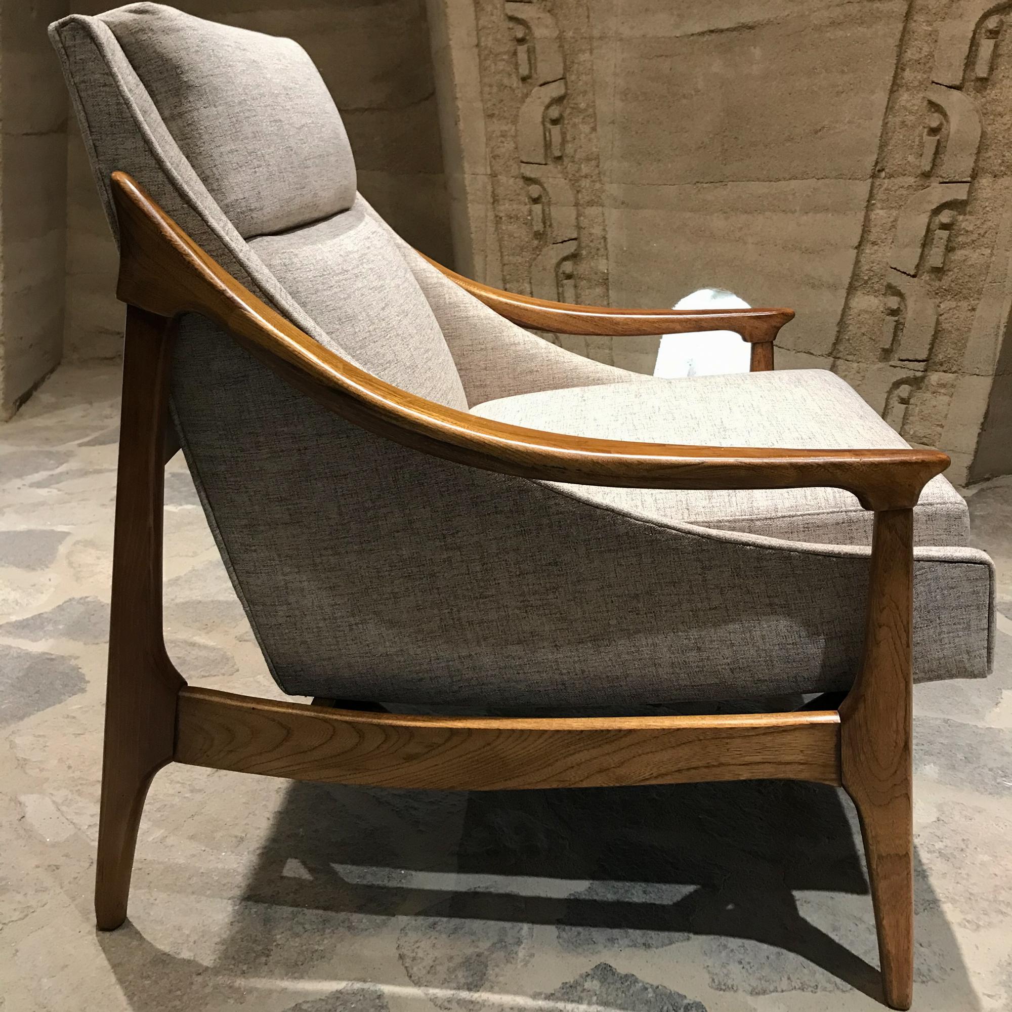 Midcentury Scandinavian Modern lounge chair with matching ottoman 1960s 
Fabulously sleek beautiful rhythmic lines in the manner of IB Kofod Larsen and Folke Ohlssen for DUX
Set has been restored. New fresh upholstery. Walnut Wood finish has been