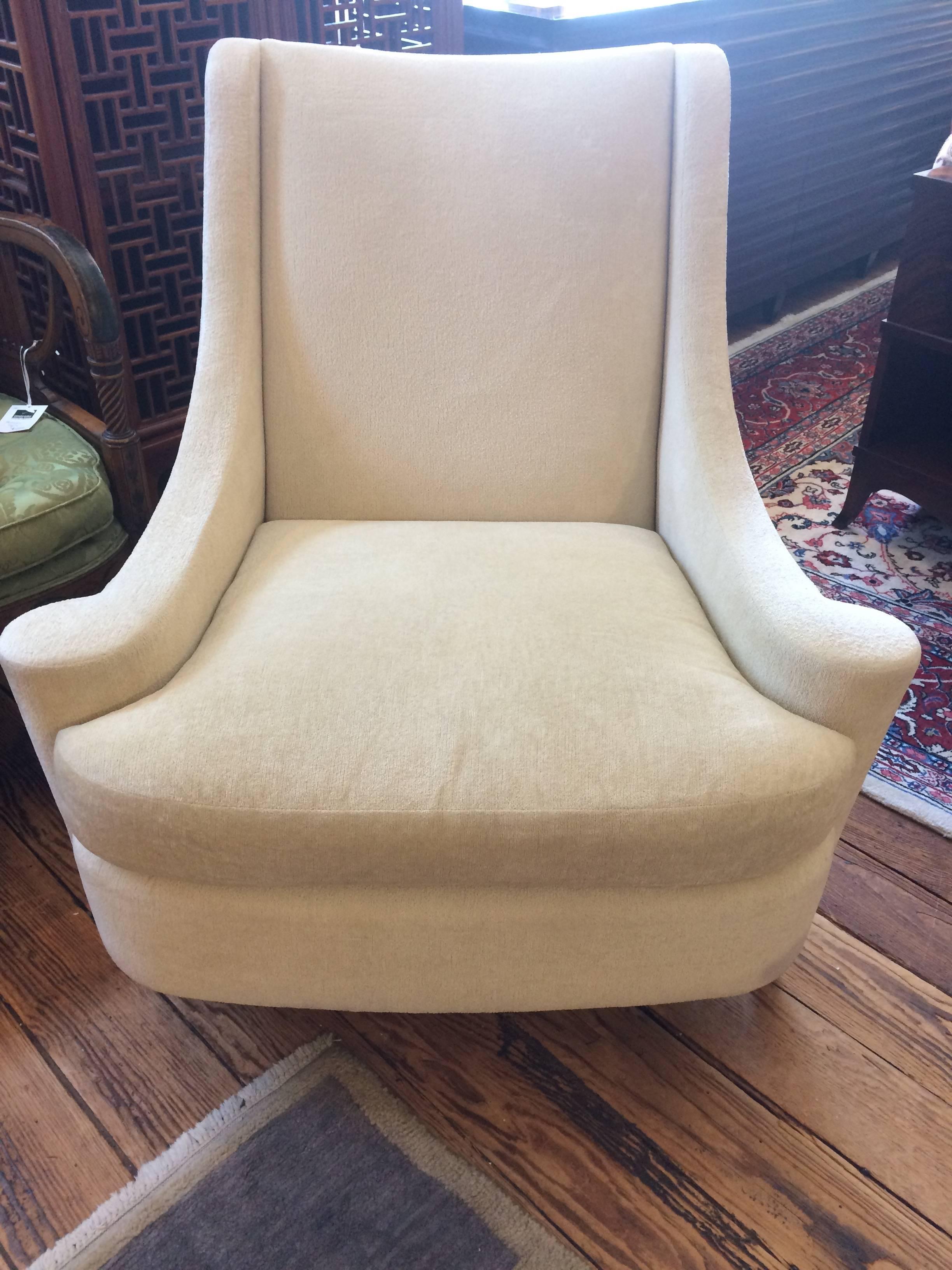 Wonderfully designed club chair called the Joan armchair by Barbara Barry having arms and seat that are wider than the top, very stylized and super comfortable. The back is tight sculpted while the seat is removeable and filled with duck