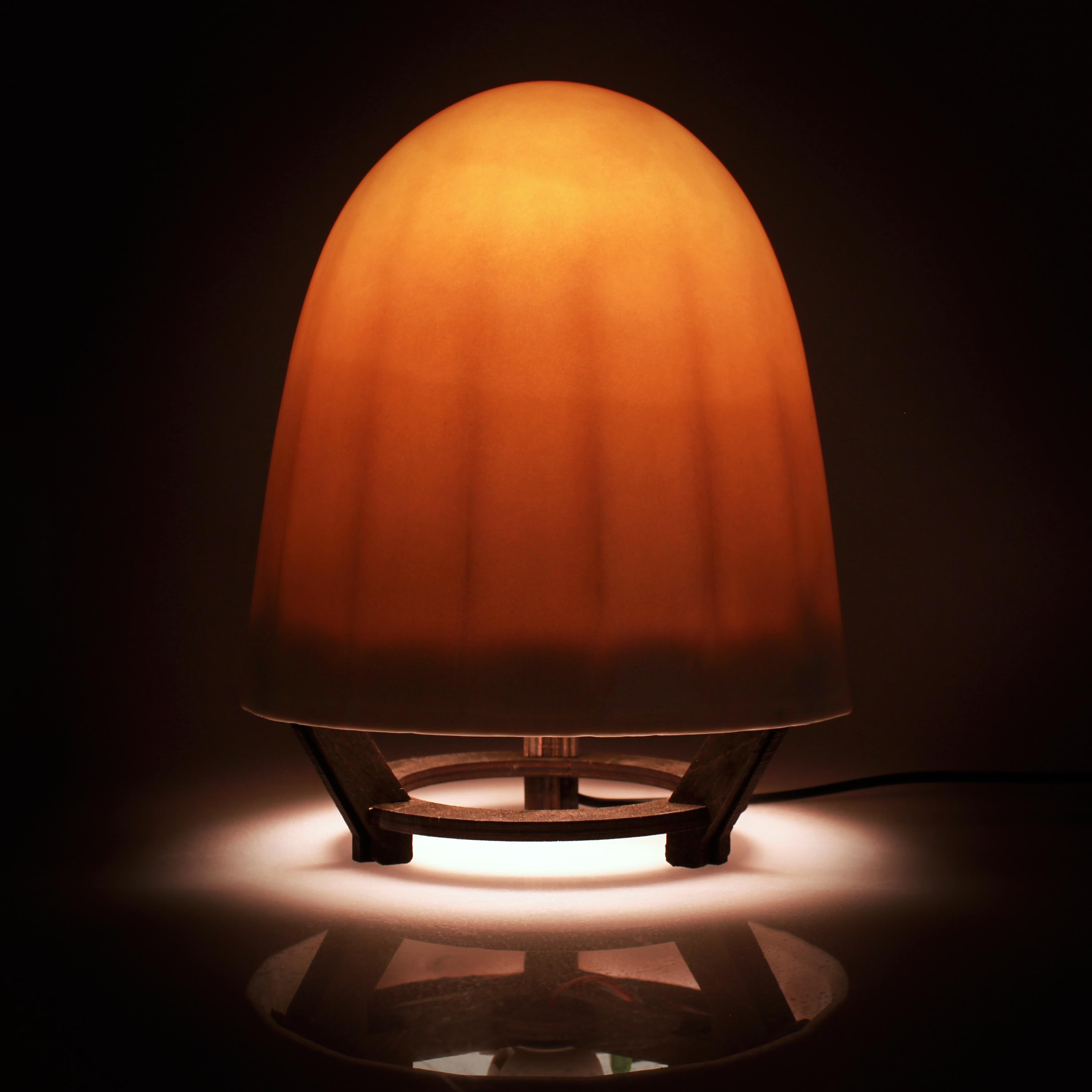 This unique translucent porcelain lamp uses capacitive-sense technology to sense your electromagnetic field and turn on and off when you hover your hand near the lower part of the shade. 

- Perfect ambient glow for bedside table lamp, yoga