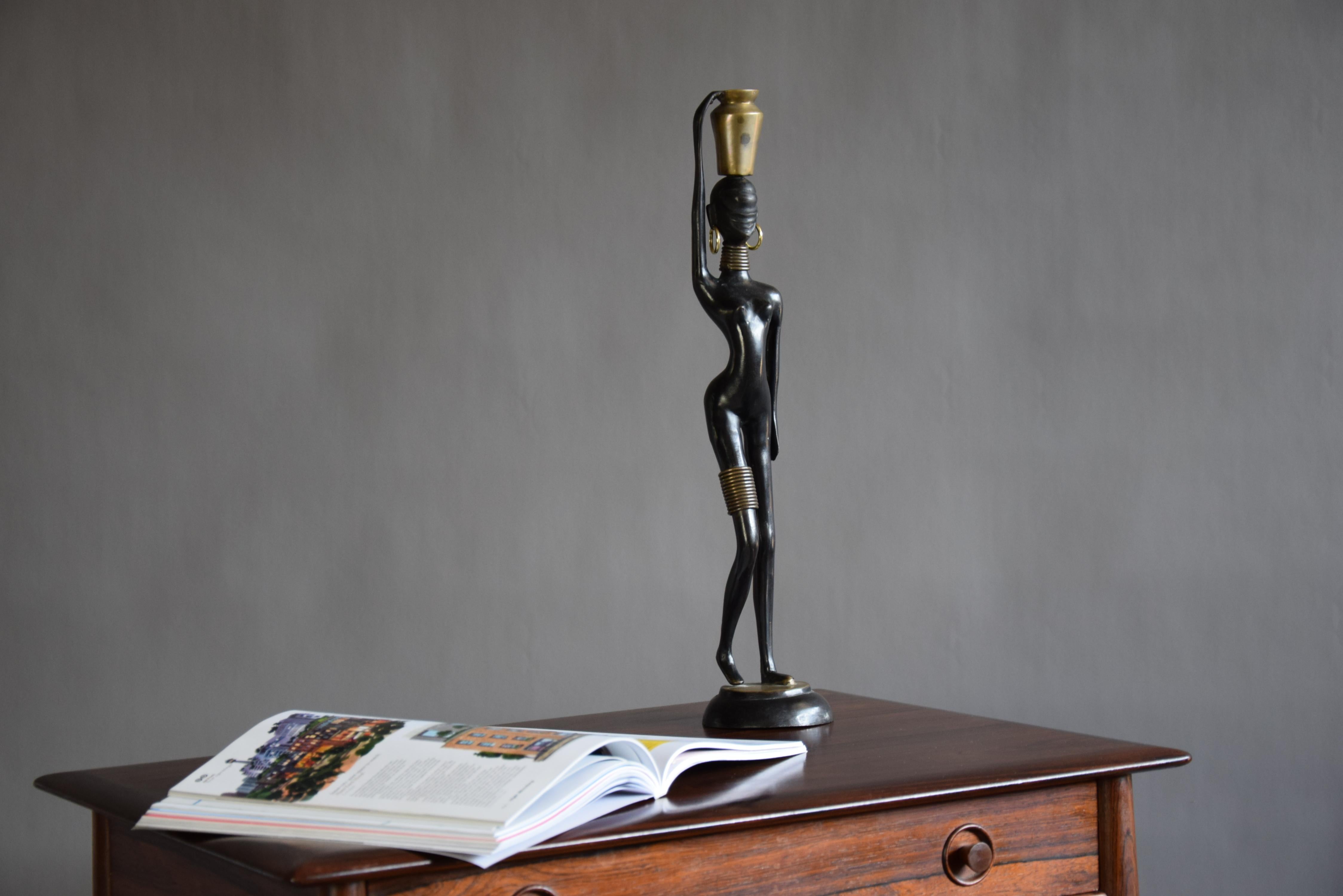 Beautiful, elegant and stylish. Bronze with black and golden patina, gilded brass. African Mid-Century Modern beauty. Made after the African neck stretching tribe known as 