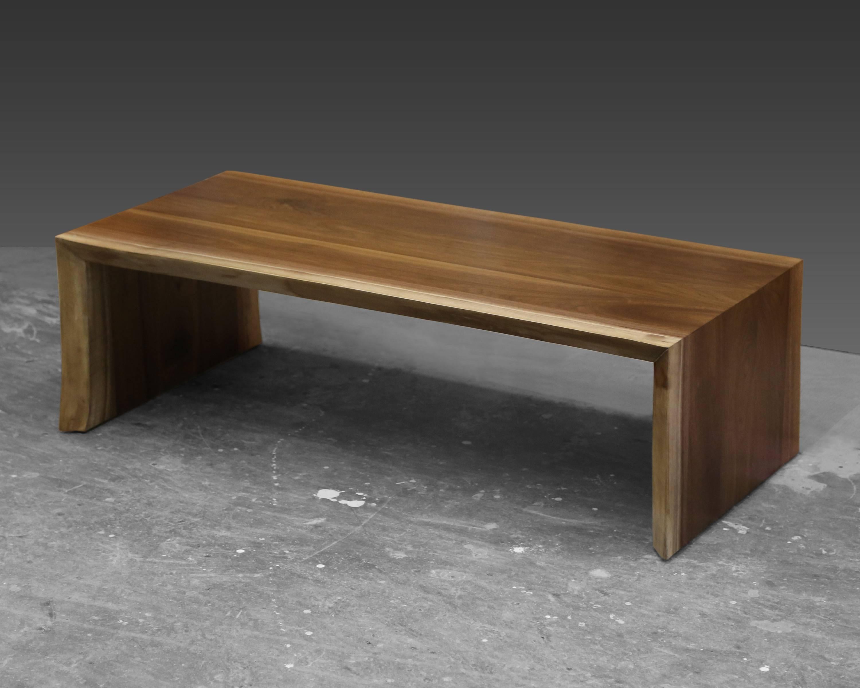 A coffee table made from a walnut live edge slab. The 