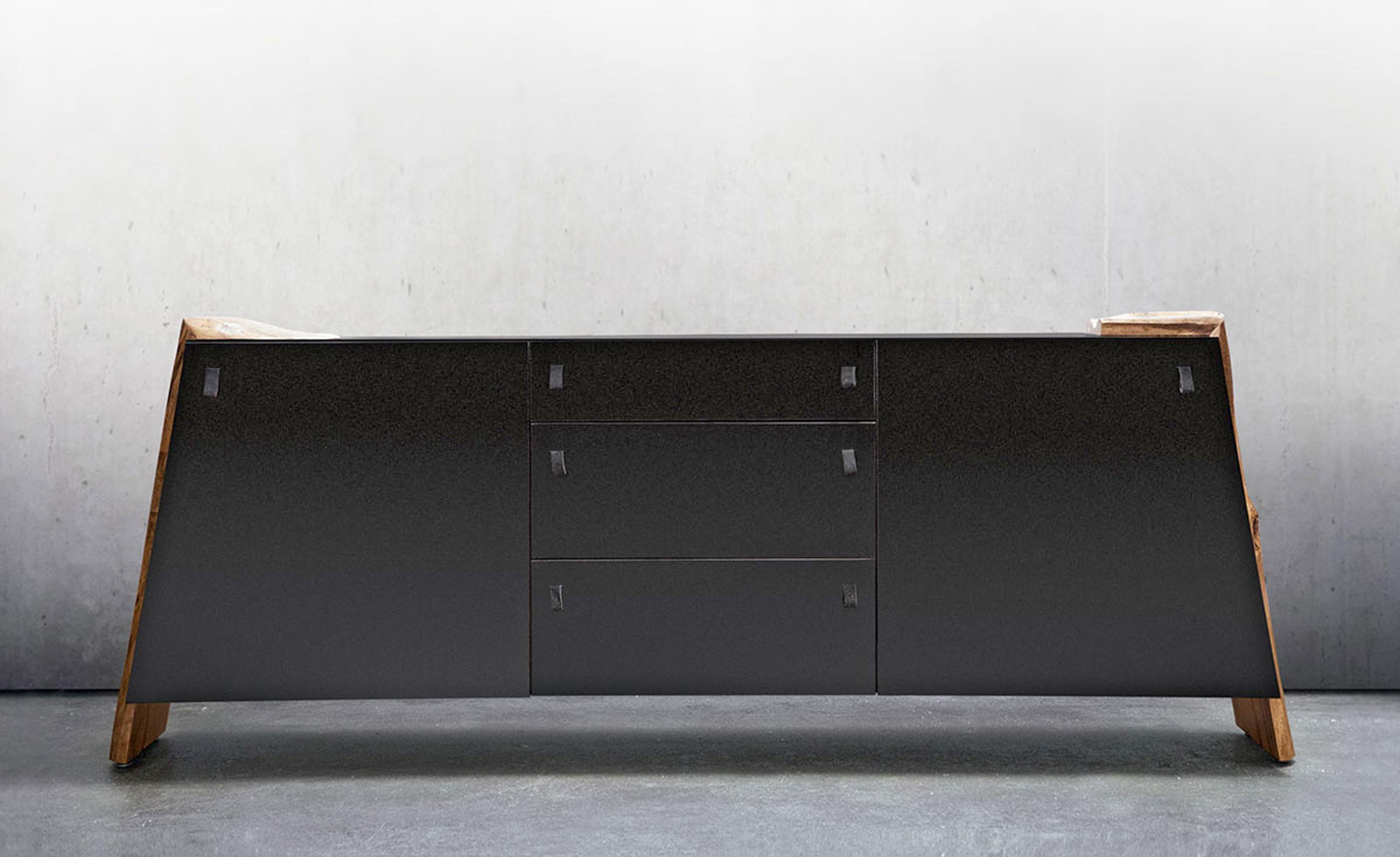 A tweaking of geometry and black finishes come together with live edge hardwood details to make an impressive statement. The Luxor credenza would make even a Pharaoh envious. Soft close hardware and leather pulls complete this piece of high