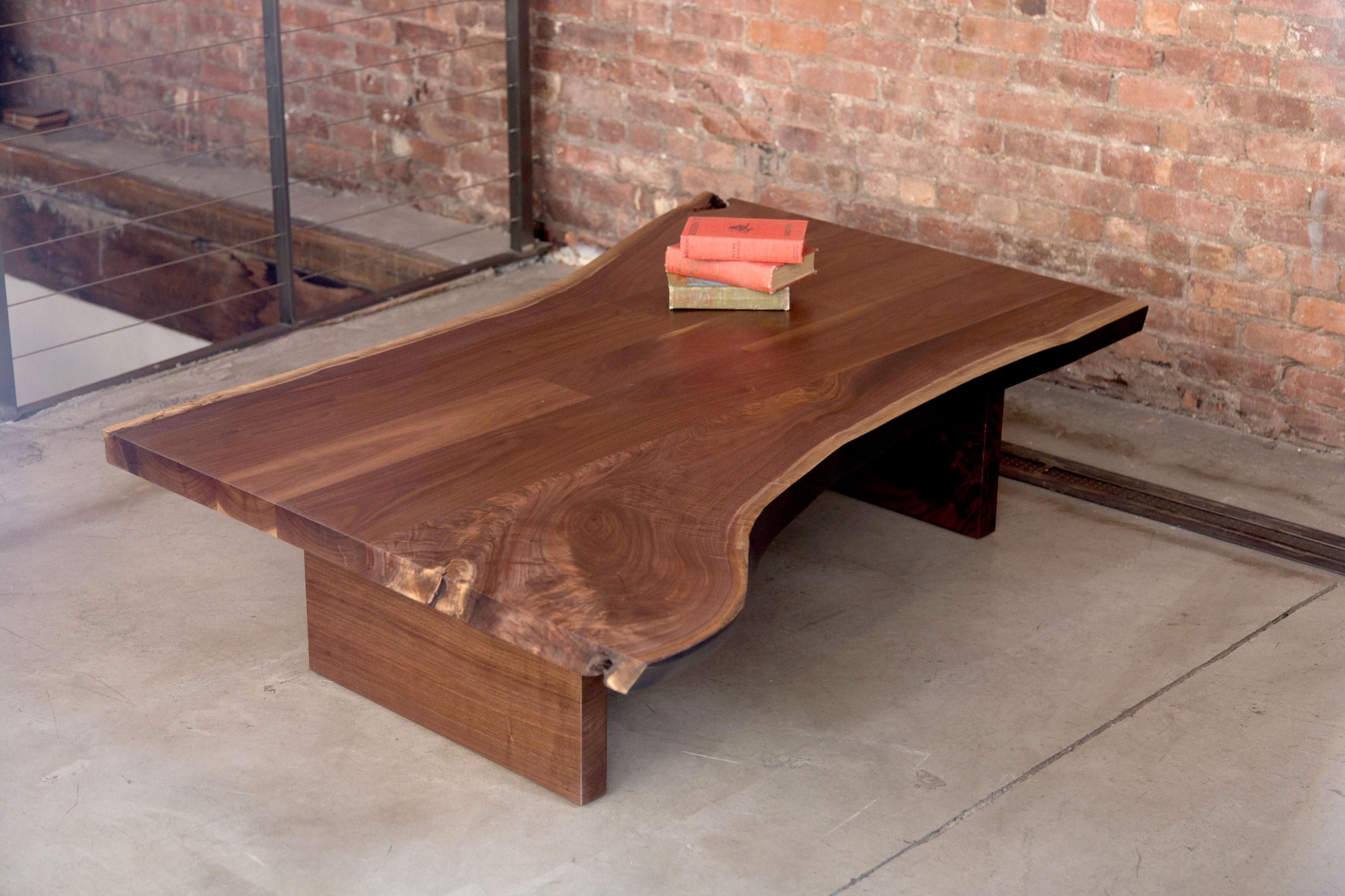 A coffee table made from a walnut live edge slab, using the same techniques and stock as our Signature dining tables. Matching block or open frame wood legs are included. 

Custom-made to order. We can match finish control samples or change the