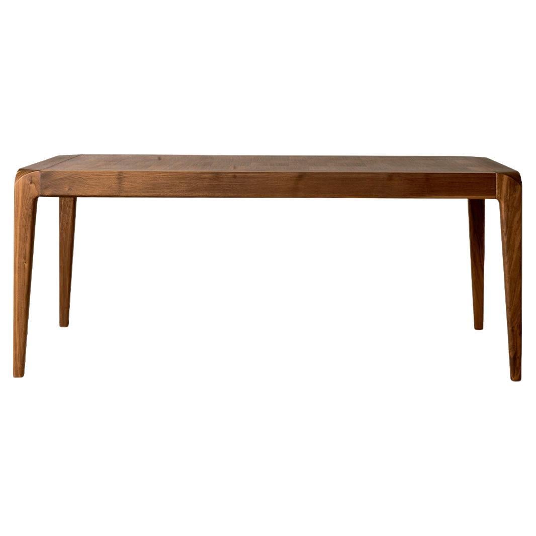 The Sentiero extendable table in solid wood is the expression of contemporary design and high quality Italian craftsmanship. Rectangular in shape, it features structure and legs in precious gray or natural walnut with inlay and wood finish. The