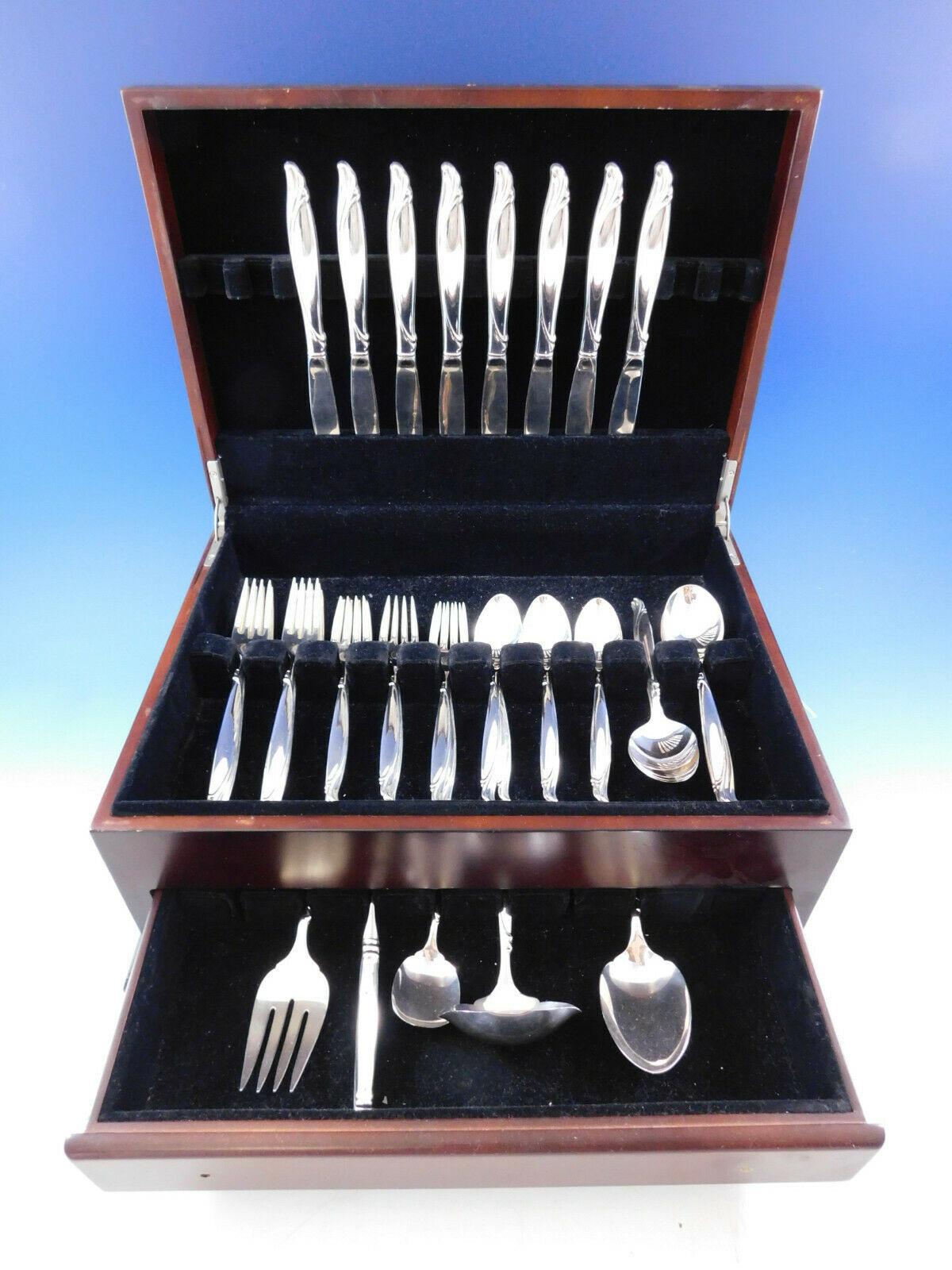 Sentimental by Oneida sterling silver flatware set, 45 Pieces. The flowing quality of the silver is expressed in this Mid-Century Modern design. This set includes:

8 knives, 9