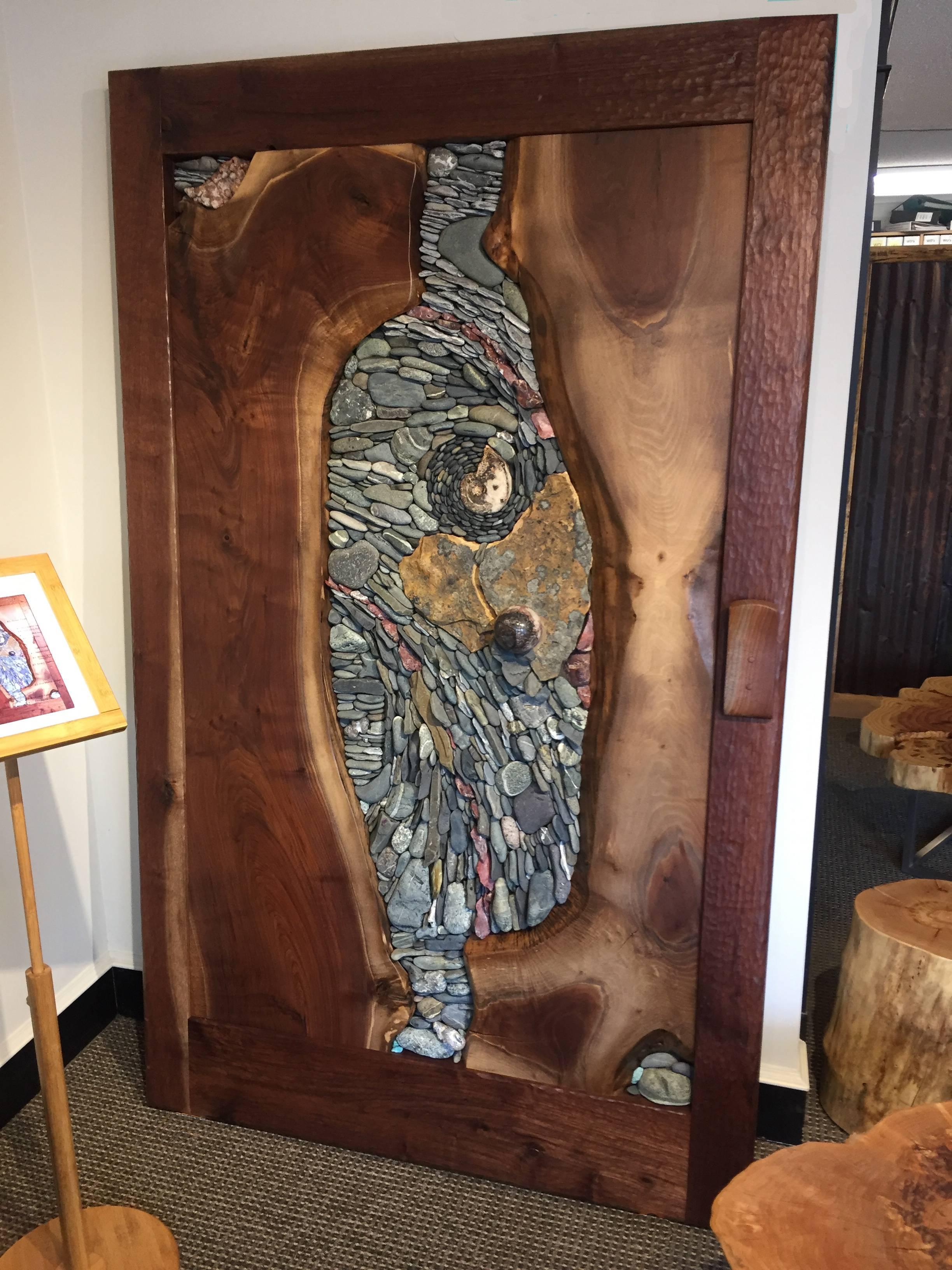 A sliding, barn style door created for the OneTree Exhibit at the Robert Bateman Centre in Victoria as a collaboration. The front features adzed solid wood frame, as well as the live edge slabs, handcrafted by Live Edge Design from solid Walnut and