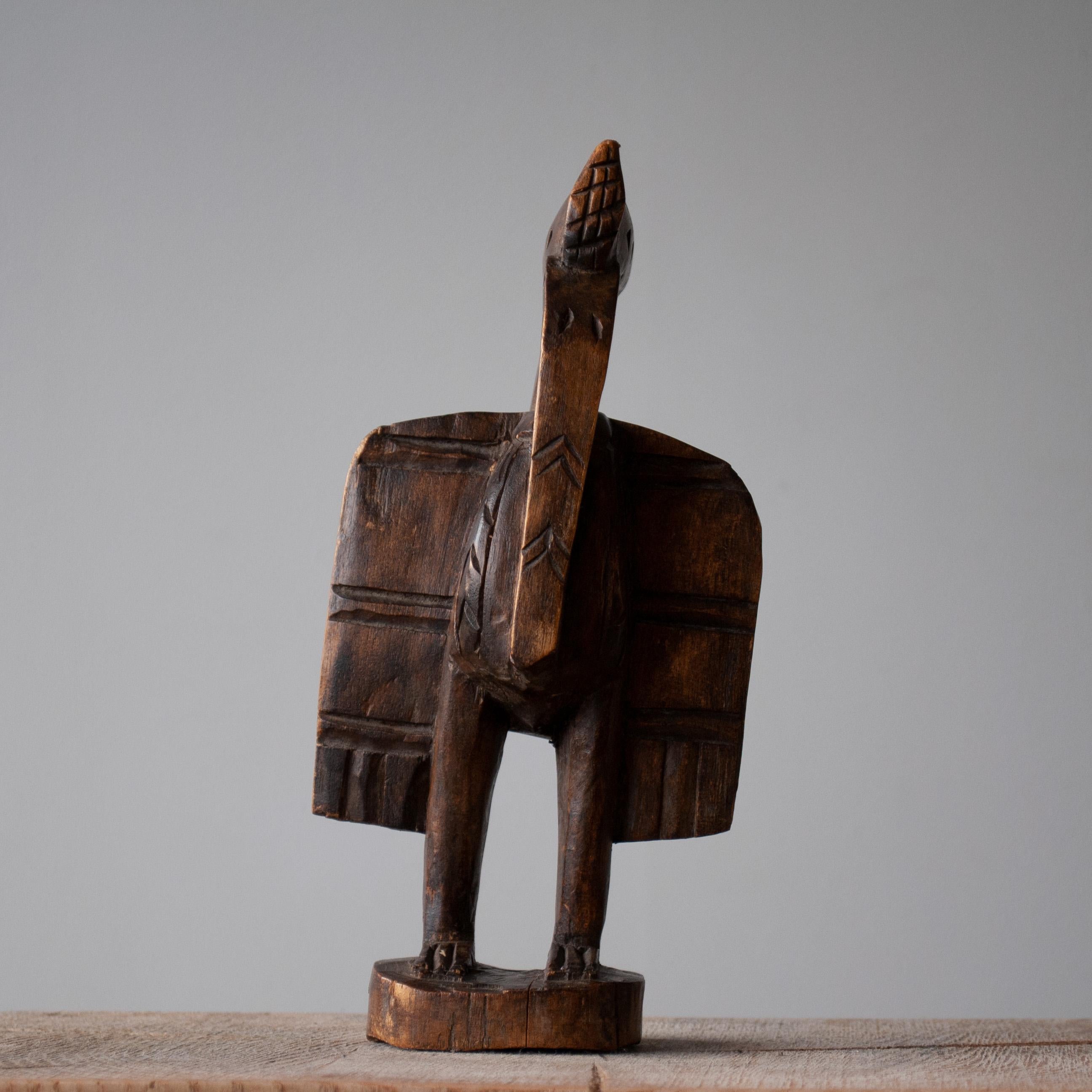 A lovely little hand carved Senufo Sejen bird sculpture from the early to mid 20th century, Africa, Ivory Coast.