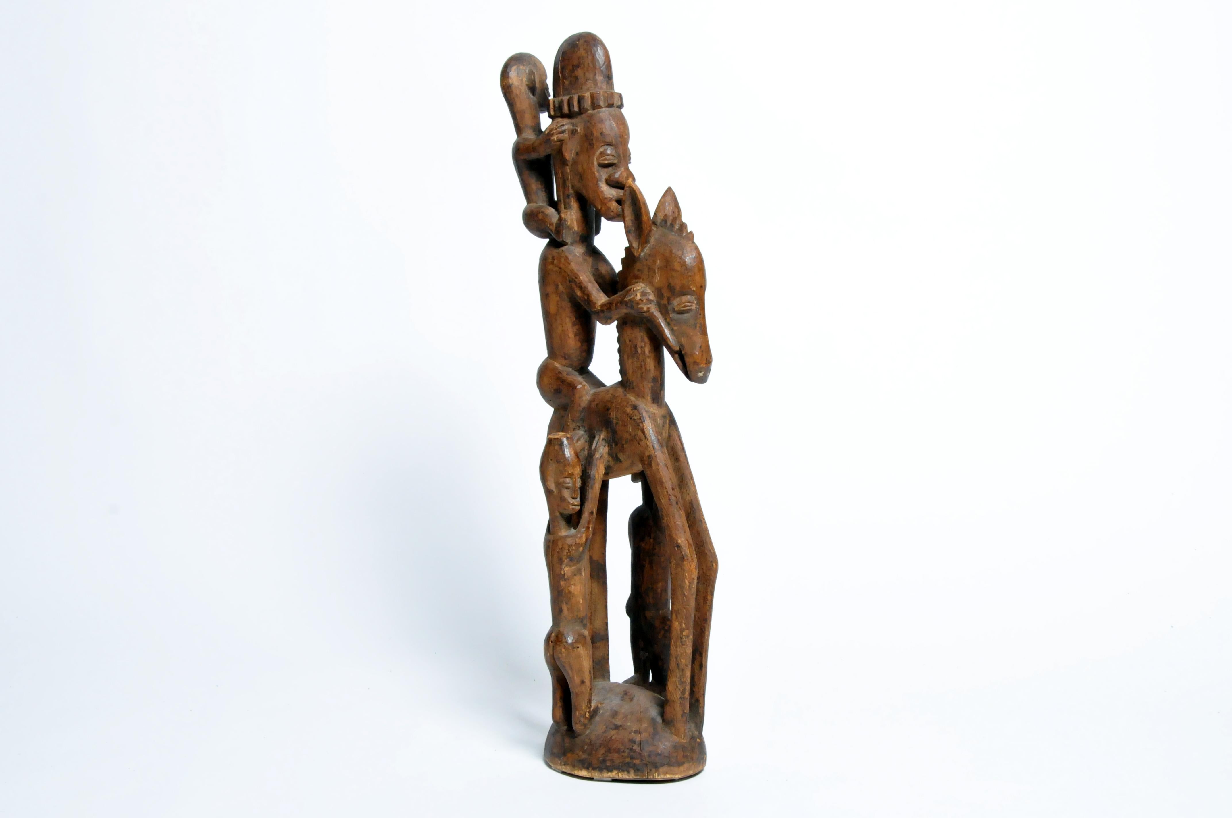This elegantly carved horse with seated rider dates to the mid-20th century. Carved softwood, species unknown. In Senufo art, the horse symbolizes power and here it is overpowered by the authority of the rider. The disproportion between the large