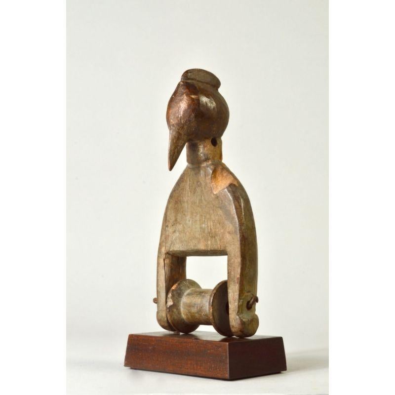 Senufo Pulley with Bird Head Finial in Wood 

This a well worn figurative pulley from the estate of Catherine Cline (née Crone, 1935-2020). Cline began collecting African art in the early 1960s in New York City through a friend, Thomas McNemar, then