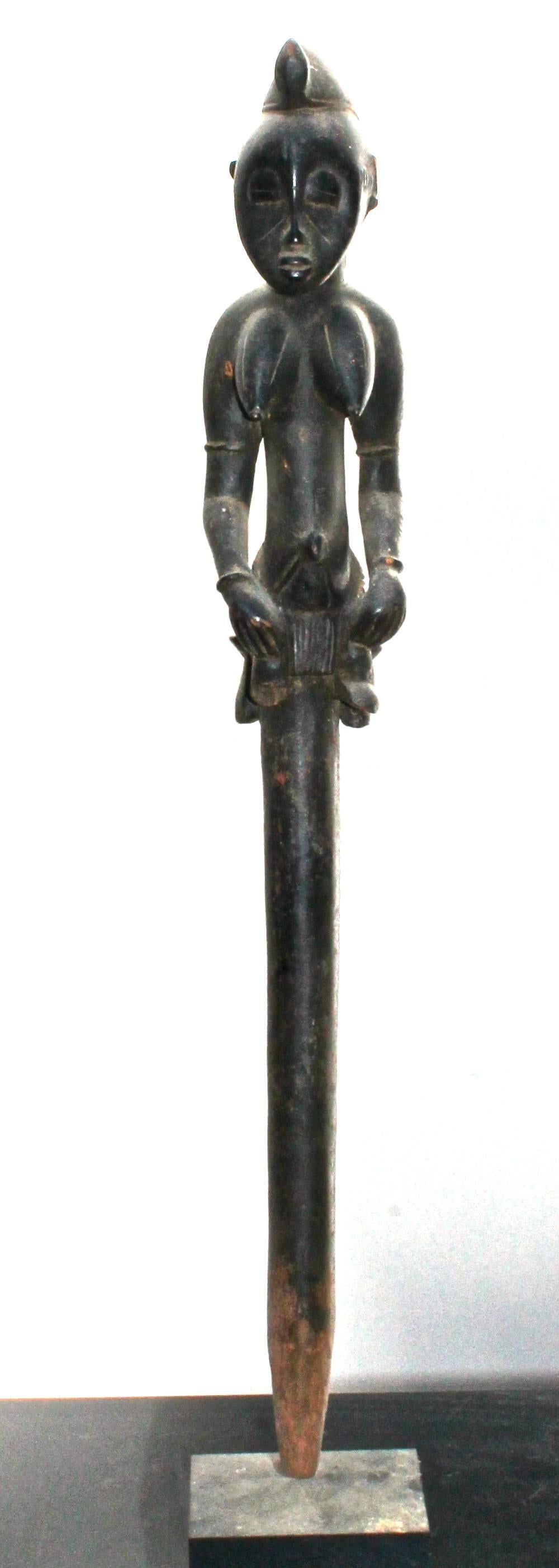 A Senufo staff depicting a seated woman. It is important that the quality and authenticity of tribal art should be equal to the quality and authenticity of the modern art it is displayed with. Provenance: Sotheby's 1998.