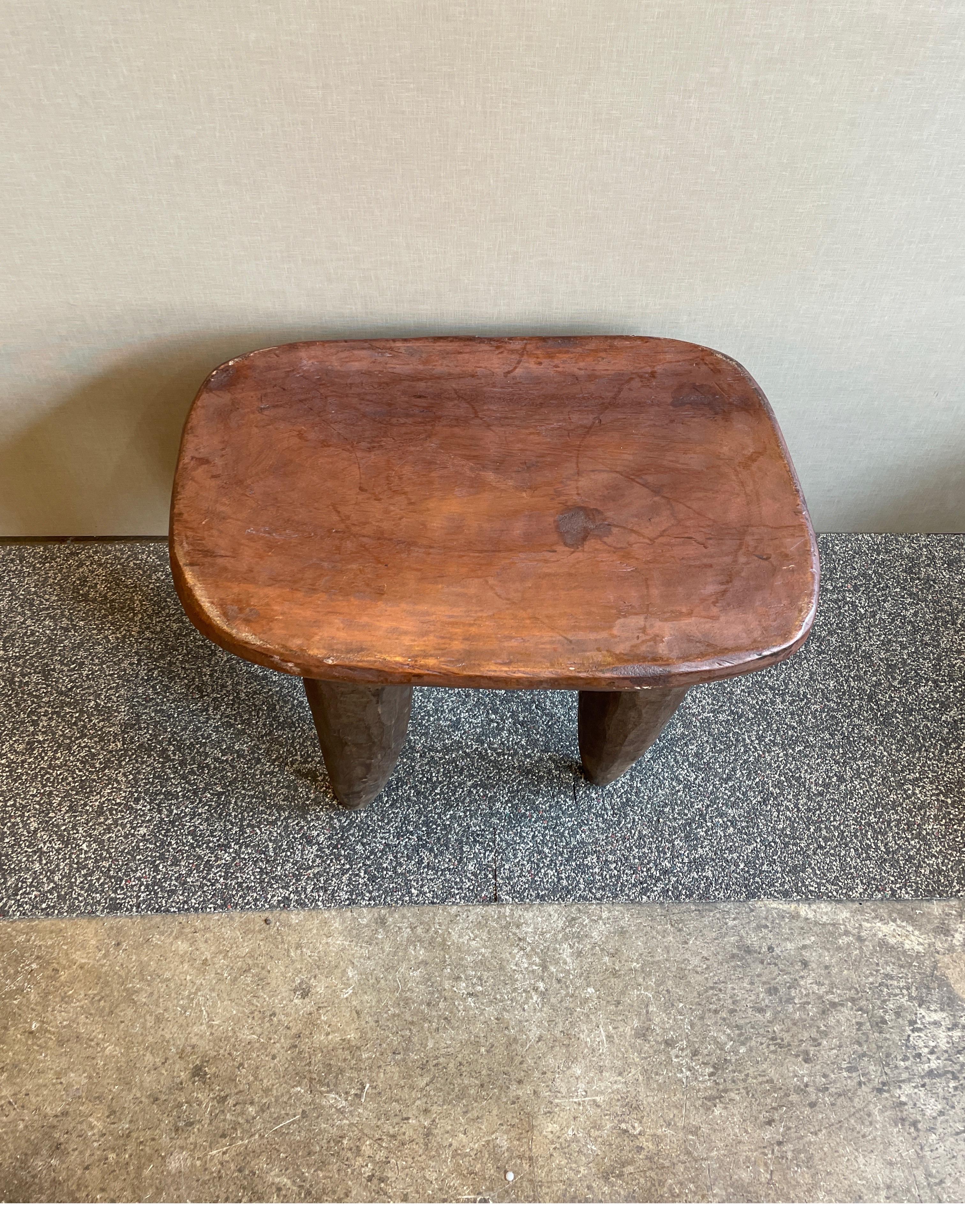 A Senufo stool or side table made from one piece of wood from the Ivory Coast. 