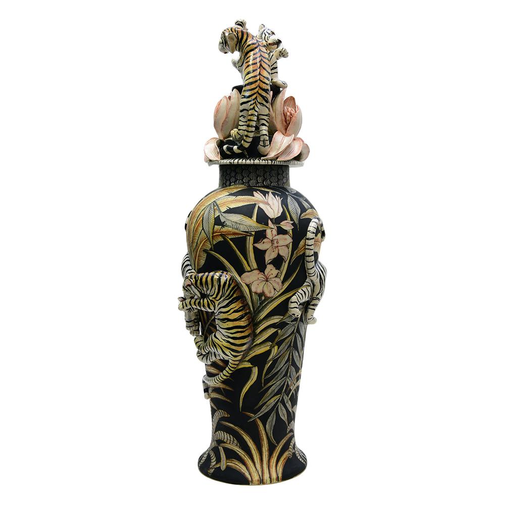 Introducing the Tiger Urn by Senzo Duma Ceramic Arts, a magnificent fusion of craftsmanship and artistry. Hand-sculpted by the talented Thabiso Mohlokoana and meticulously hand-painted by Senzo Duma in South Africa, this large ceramic vase stands at