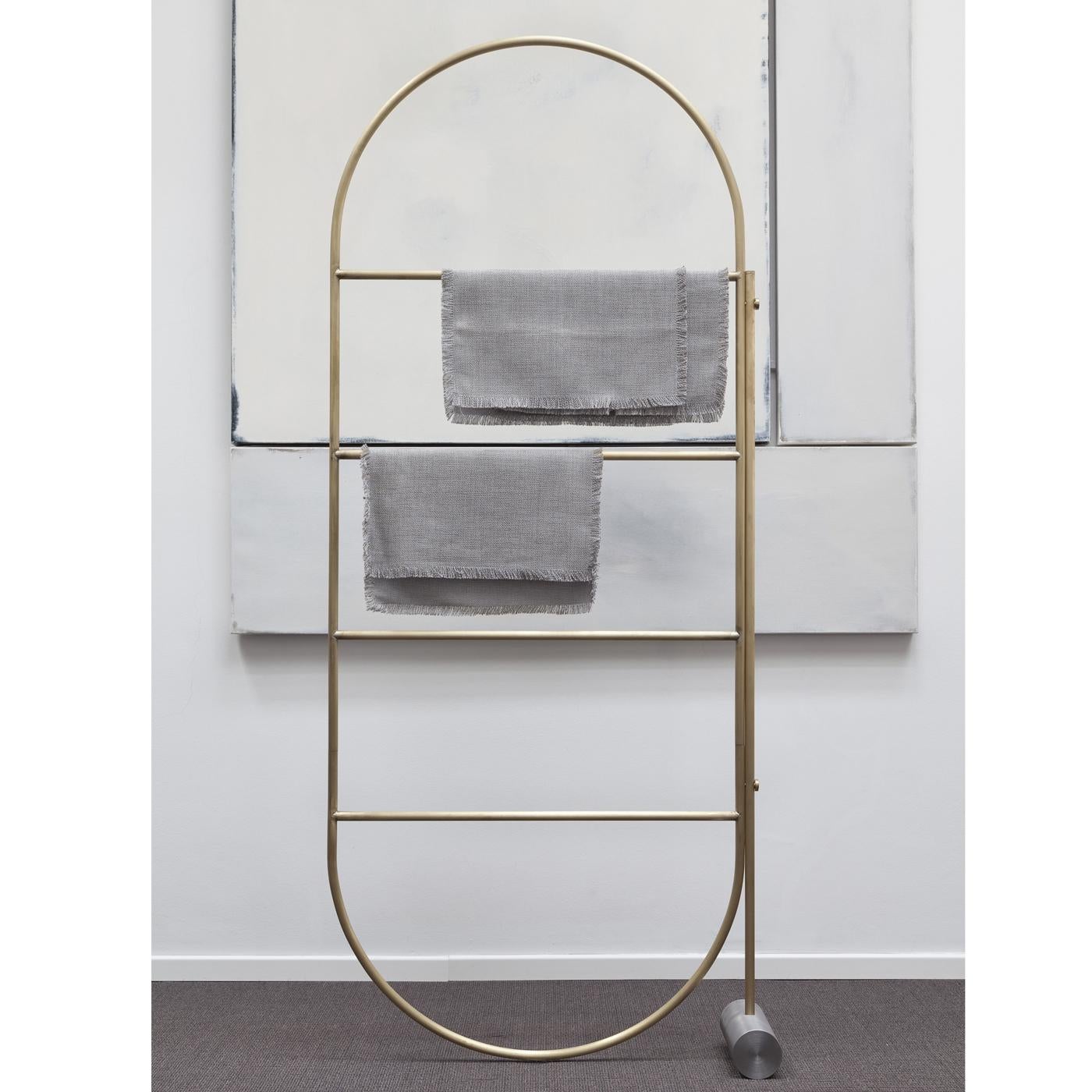 This versatile divider is a multi-functional piece of design that can be crafted in brass or varnished iron. It was made entirely by hand and its vertical metal frame mixes with the gentle curves of its top and bottom. The translucent natural fabric