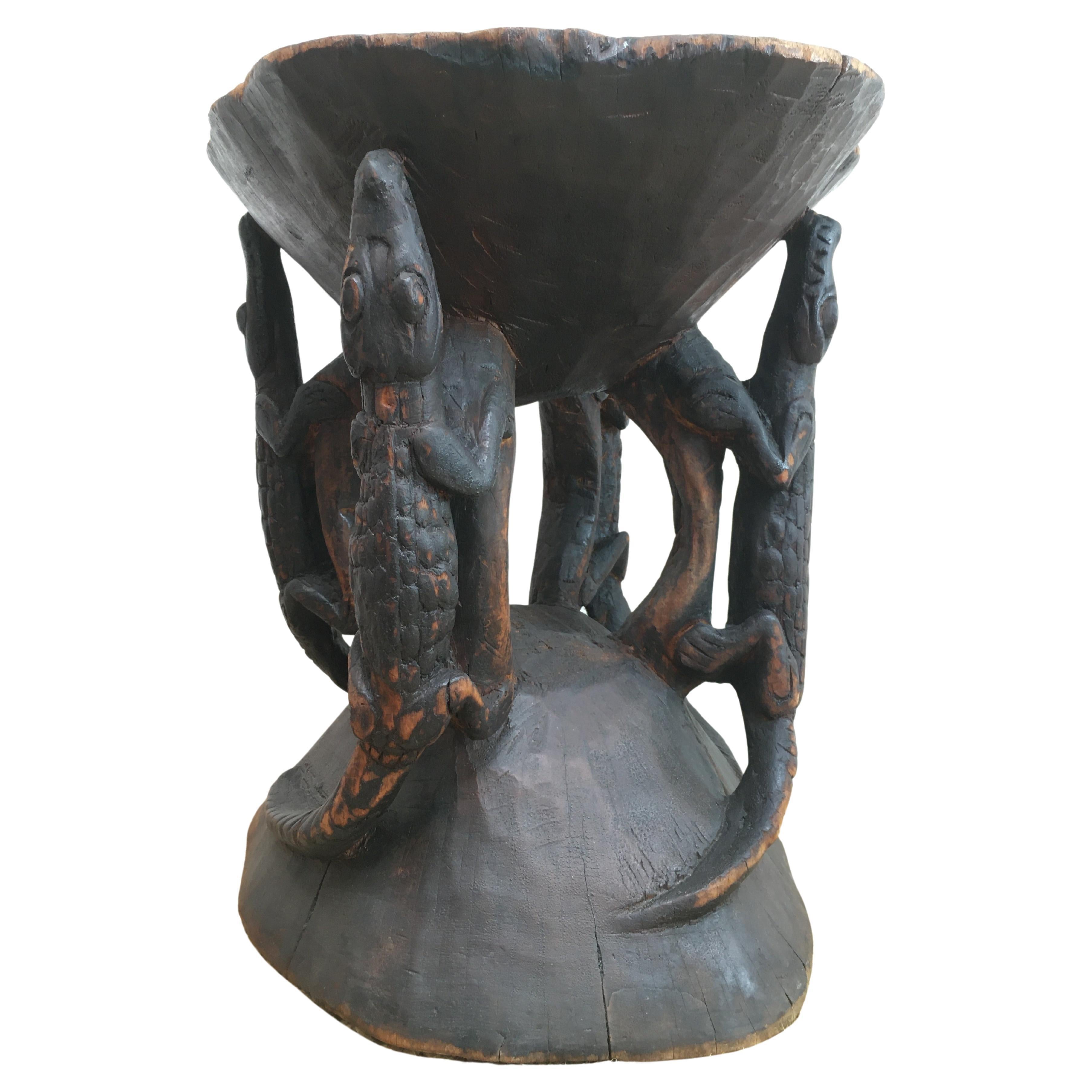 A mid 20th Century Sepik River Crocodile stool, hand carved from a single piece of solid timber. 

We suspect this stool is from the period immediately after the Second World War. Its previous owner relayed to us that it was sourced directly from
