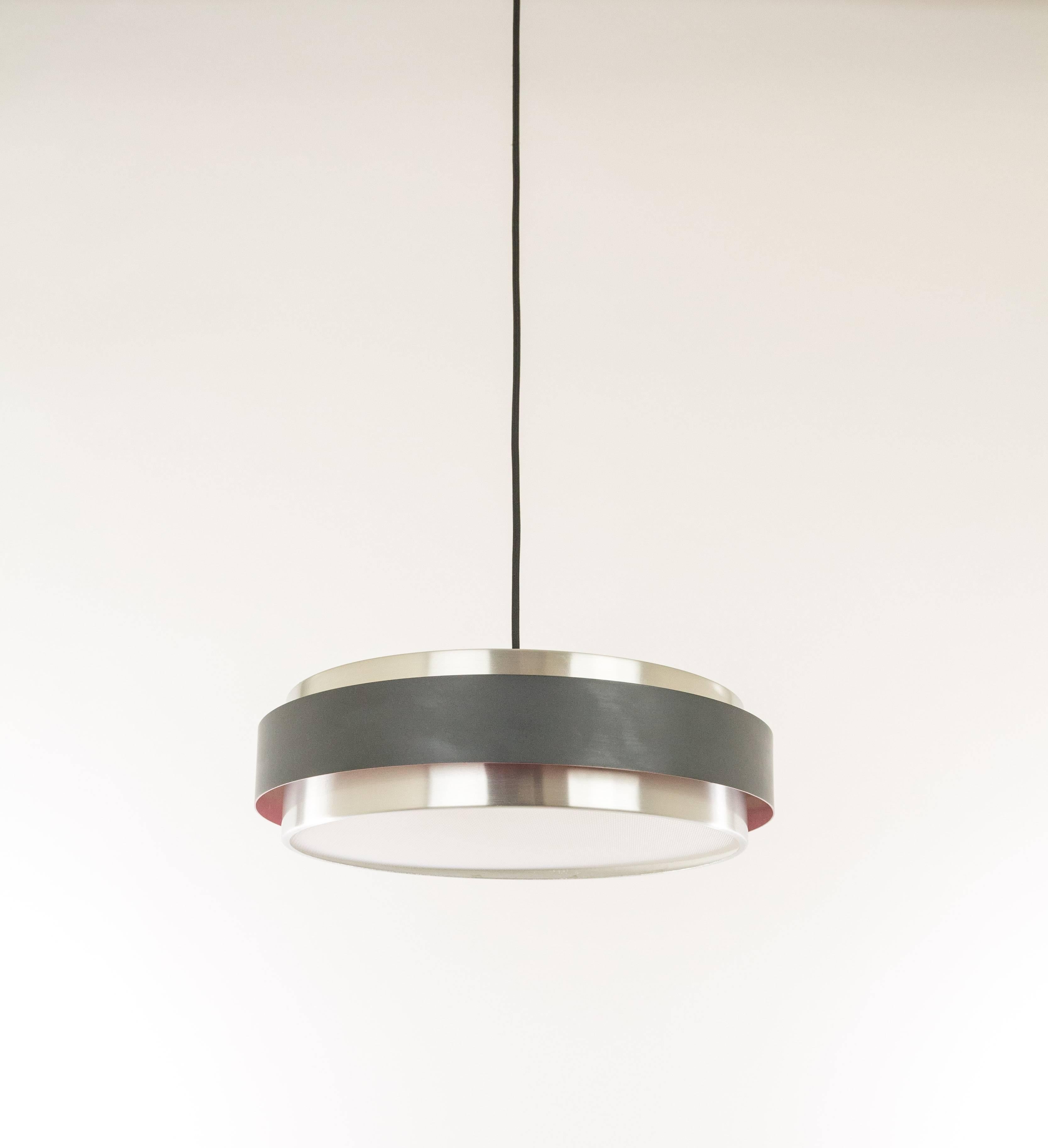 Sera is a 1960s pendant designed by Jo Hammerborg for Fog & Mørup. The lampshade is made of three brushed aluminium disks. The top and bottom ones are silver coloured and the central circular shade is lacquered black on the outside and purple on the