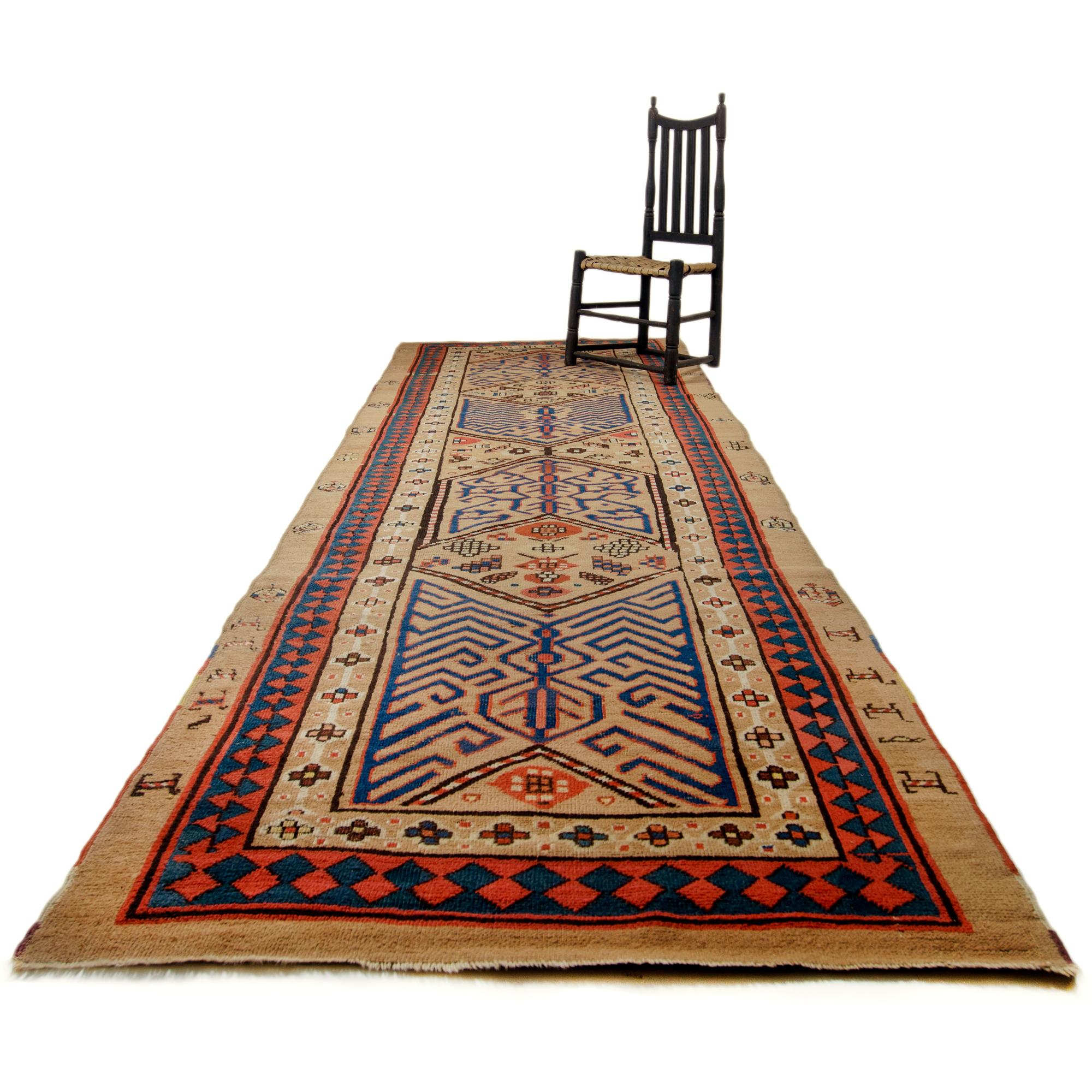 An antique Serab rug runner, Persia, late 19th century.

Red and blue on natural, undied camel hair.  

Unique geometric design with animals in the margin. 

3’6” by 10’9”

42 by 129

