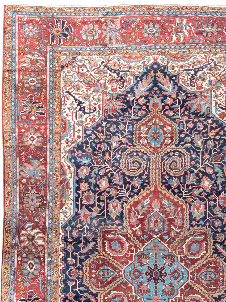 Antique Large Oversized Persian Serapi Carpet, 19th Century

This fantastic oversized Serapi carpet paints a ruby-red lobed medallion against an indigo ground. A network of flowers and full palmettes blossom from meandering scrolls throughout the