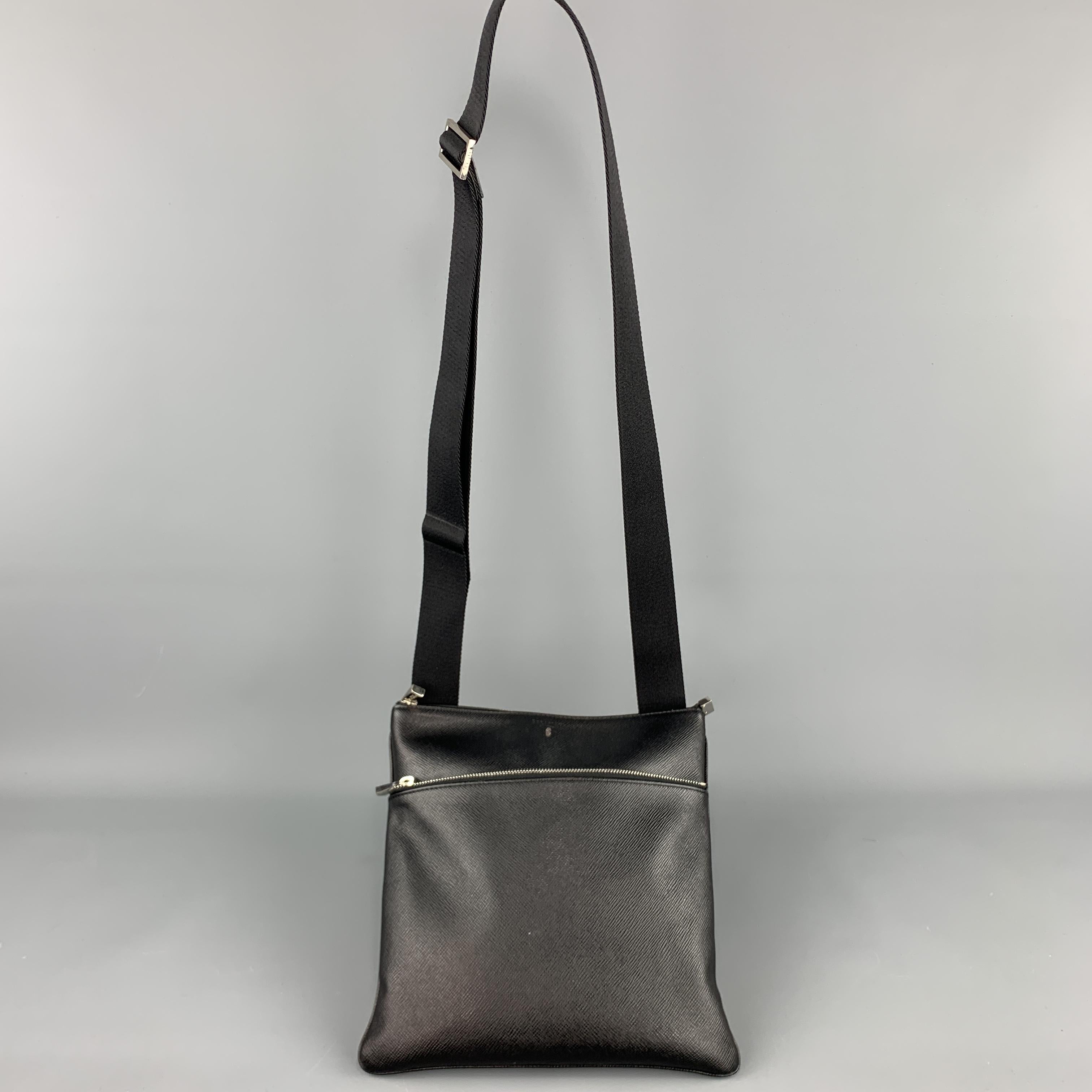 SERAPIAN crossbody bag comes in black Saffiano textured leather with zip pocket and webbing strap. Made in Italy.

Very Good Pre-Owned Condition.

Measurements:

Length: 10.5 in.
Width: 1 in.
Height: 10.5 in.
Drop: 29 in.