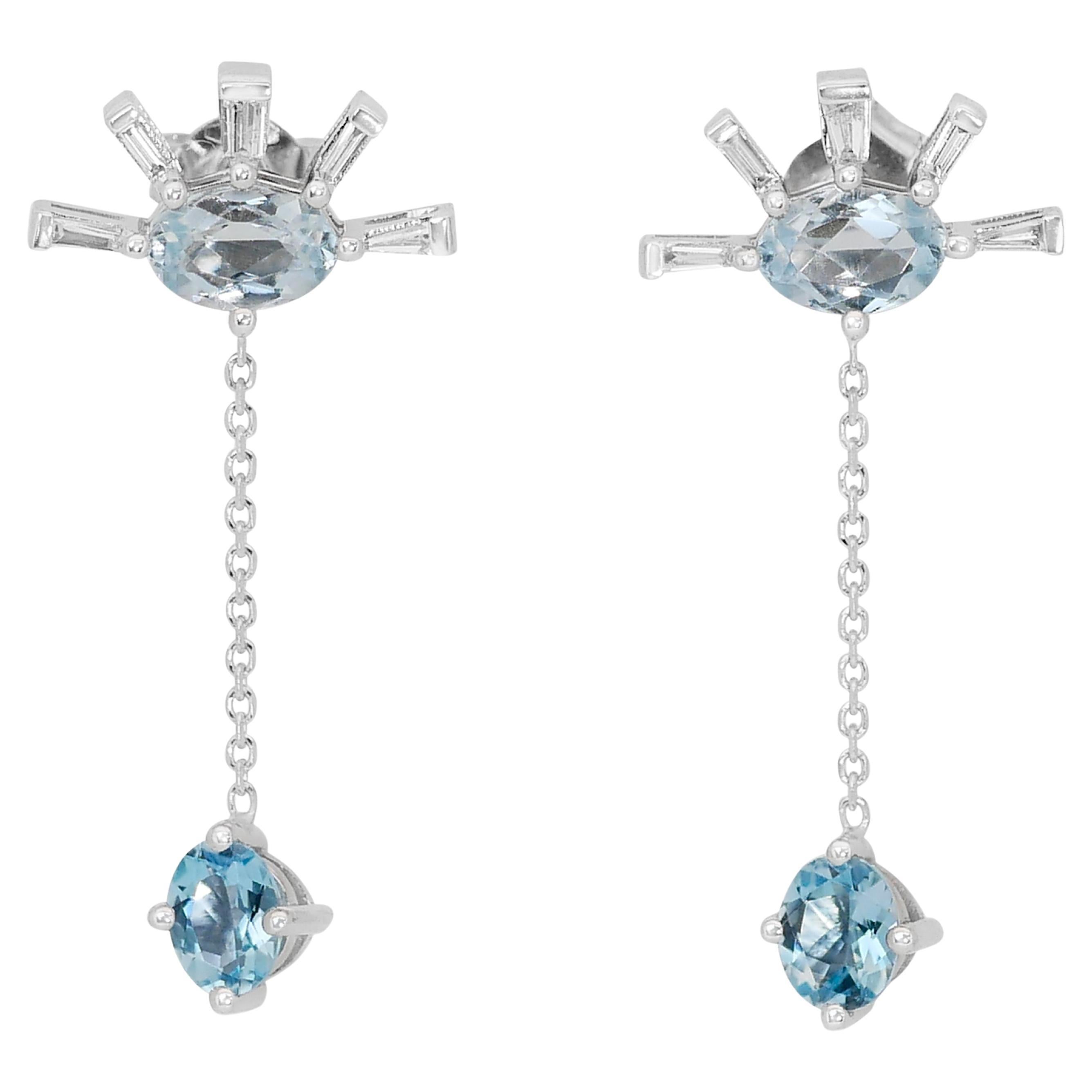 Serene 14k White Gold Blue Topaz and Diamond Drop Earrings w/2.12 ct - IGI Certified   

Introducing the Serene Blue Topaz and Diamond Elegance, a pair of 14k White Gold Dangling Earrings. The main stones are 2 light blue Topaz of 1.20 ct,