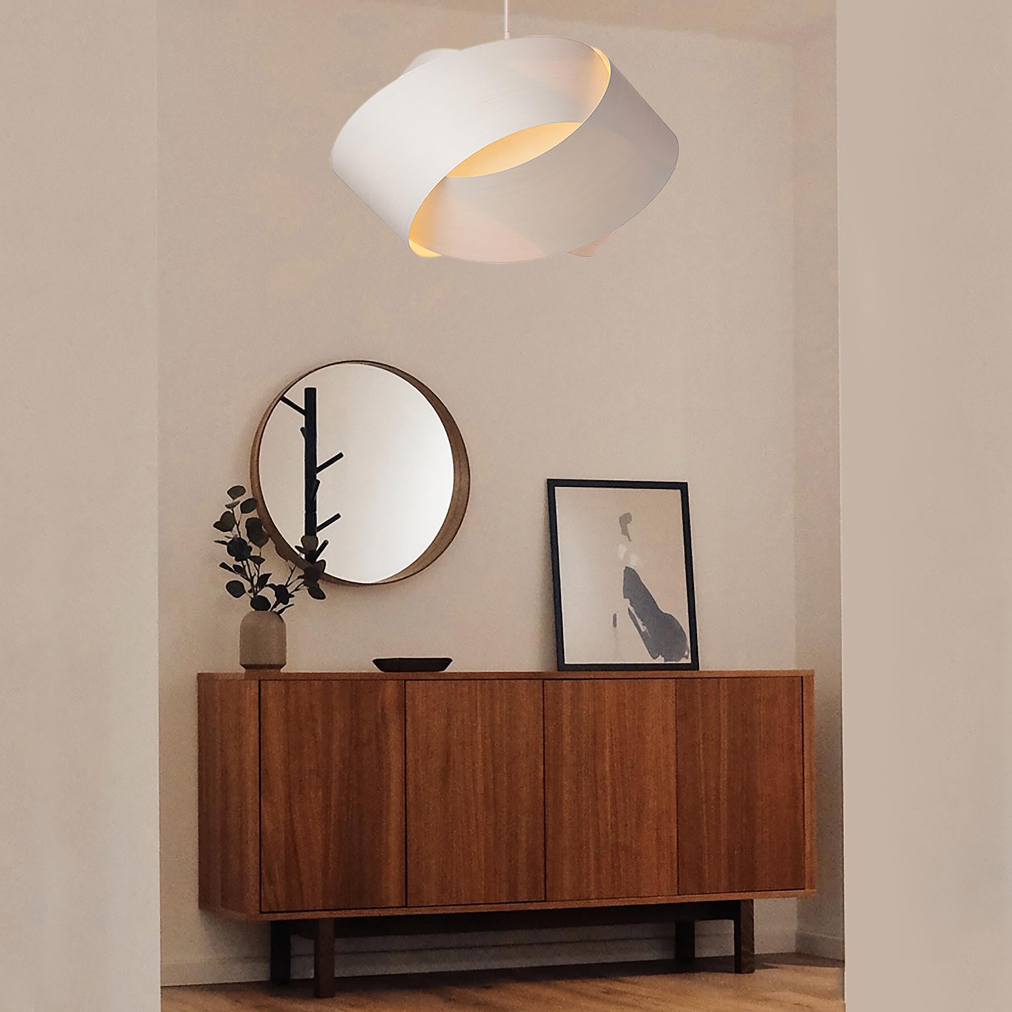 The Serene pendant light is a contemporary, Mid-Century Modern light fixture with a Scandinavian design and organic modern composition. This minimalist luxury wood veneer pendant design is the perfect way to add a touch of nature and elegance to