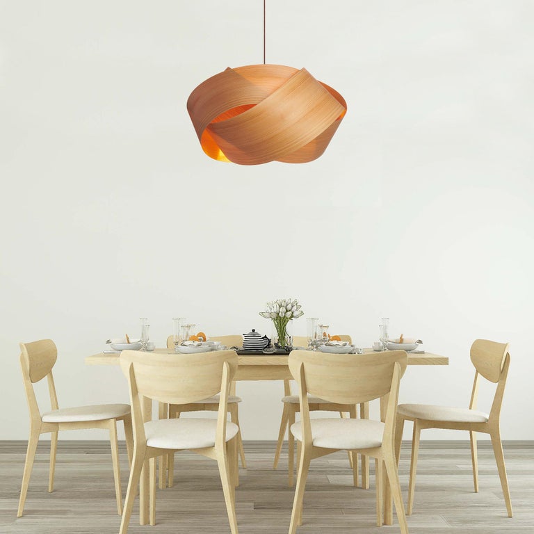 This Scandinavian modern chandelier pendant is a contemporary lighting fixture in a rare wood veneer with a Danish design style and an organic modern feel. There are many luxury design applications for this pendant, in dining rooms, entryways or