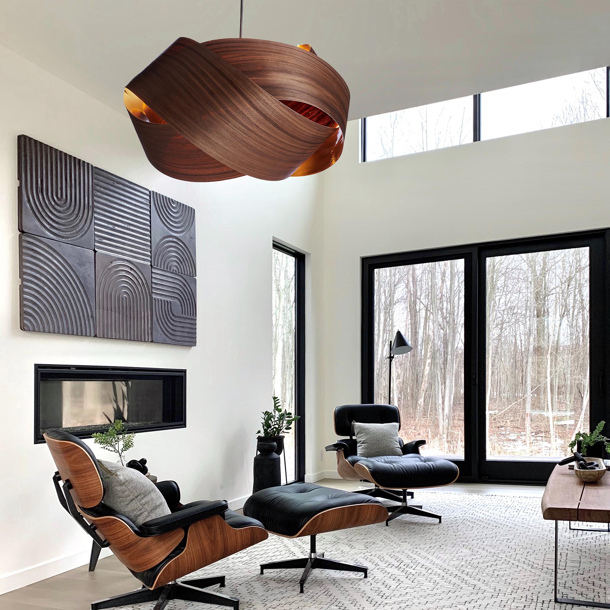 The Serene pendant light is a contemporary, Mid-Century Modern light fixture with a Scandinavian design and organic modern composition. This minimalist luxury wood veneer pendant design is the perfect way to add a touch of nature and elegance to