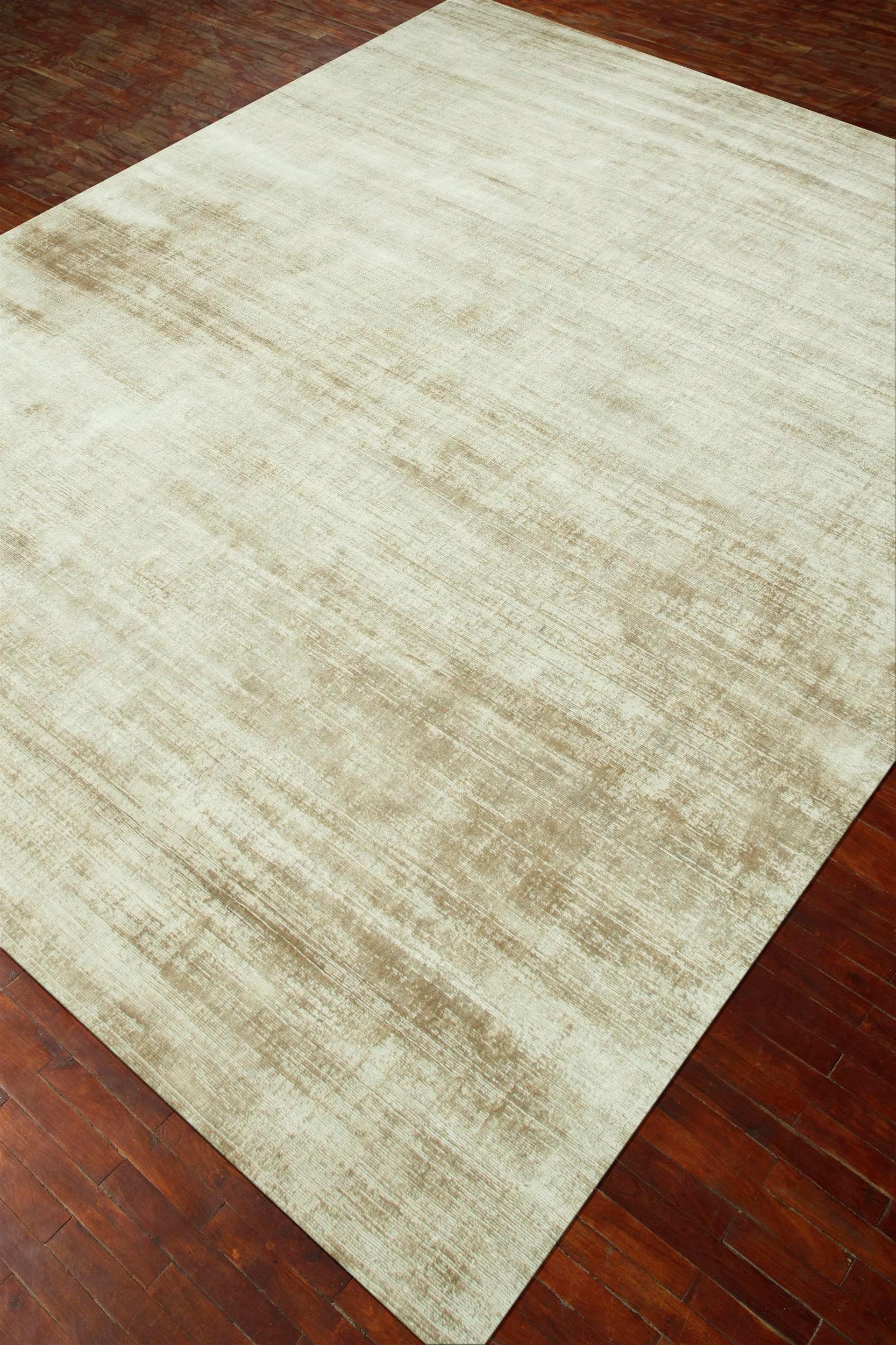 What whispers of modern elegance and timeless sophistication does this hand-loom rug by evoke? Crafted with precision and passion, each thread intertwines to create a masterpiece of simplicity and grace. Picture the perfect first impression, gently