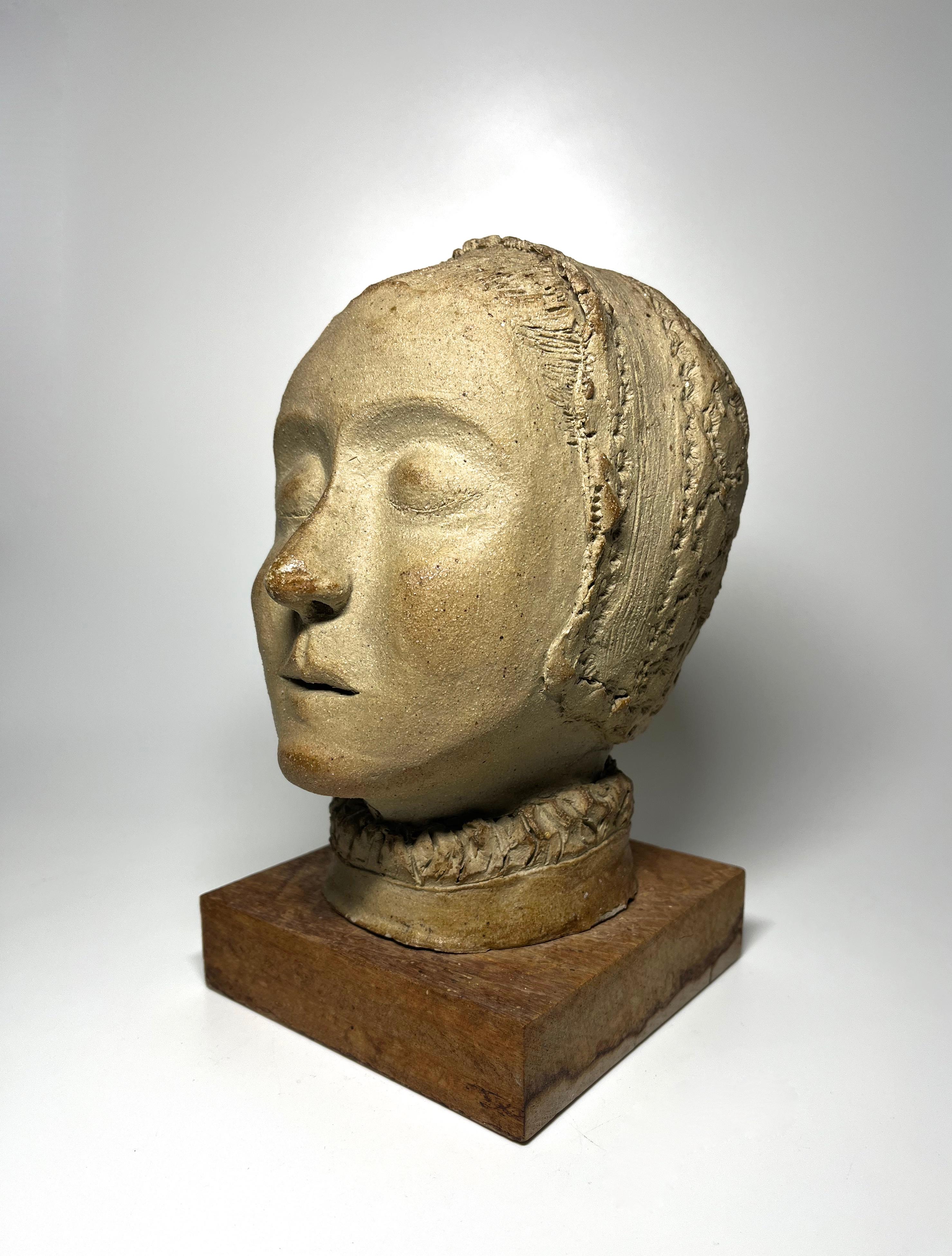 Graceful study of a young Elizabethan woman in natural clay
Eyes closed, wearing a close fitting coif and petite ruff - perhaps a final true portrait 
Signed with initials E J to nape of neck
Stands freely on a simple wooden plinth
Circa