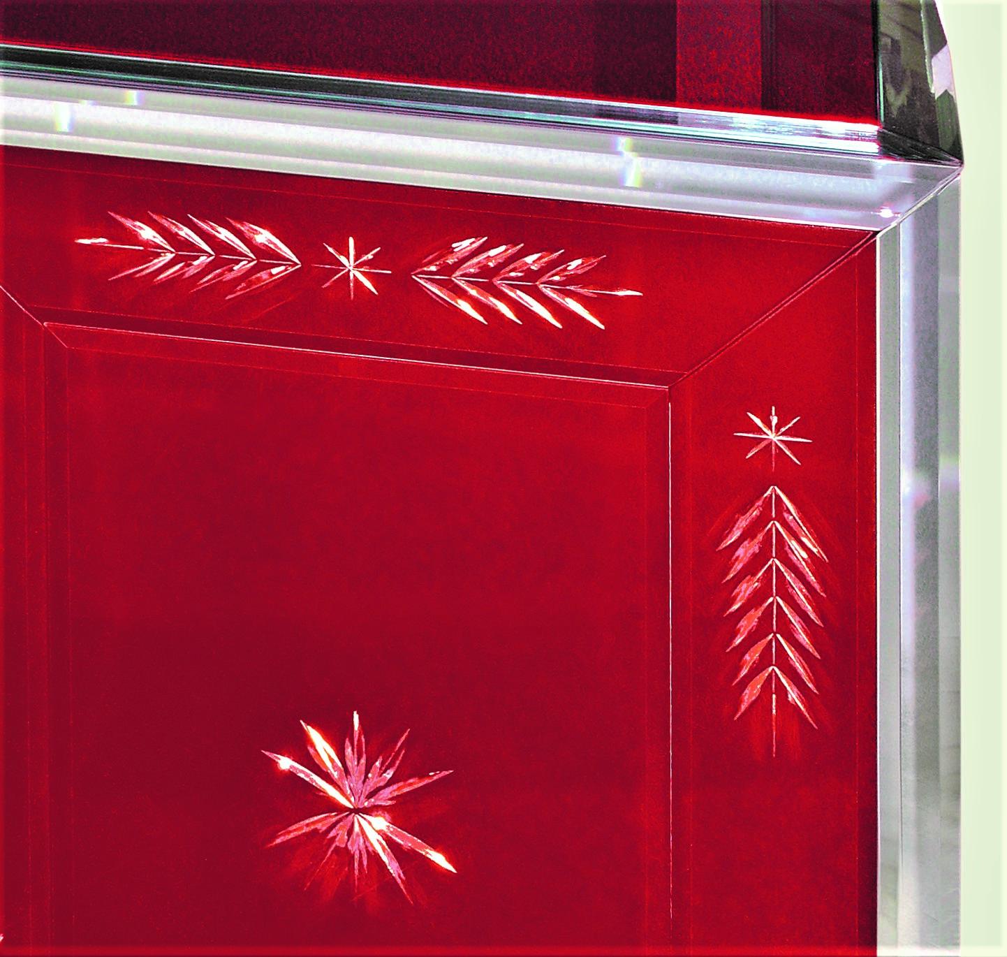 Murano glass sideboard, composed of three doors, covered in red mirror, with finishes and legs in clear mirror, all beveled, itagliata, wheel engraved and hand polished, with pure silver silvering following the ancient techniques of the Murano glass