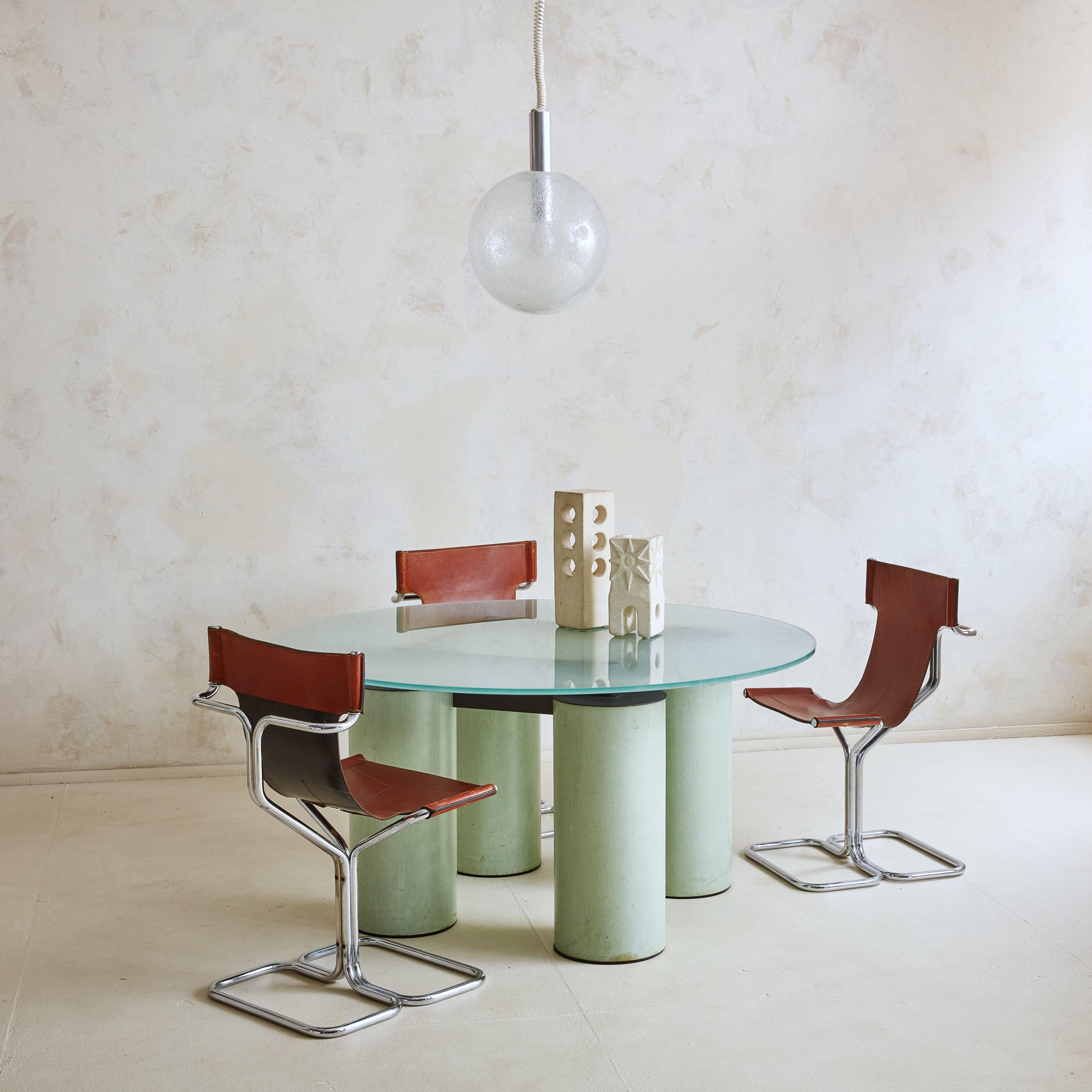 A striking ‘Serenissimo’ series dining table from 1985 by the infamous design duo Lella & Massimo Vignelli for Acerbis Italy. This Postmodern dining table features four oversized column-form legs composed of metal finished with pigments and resin in