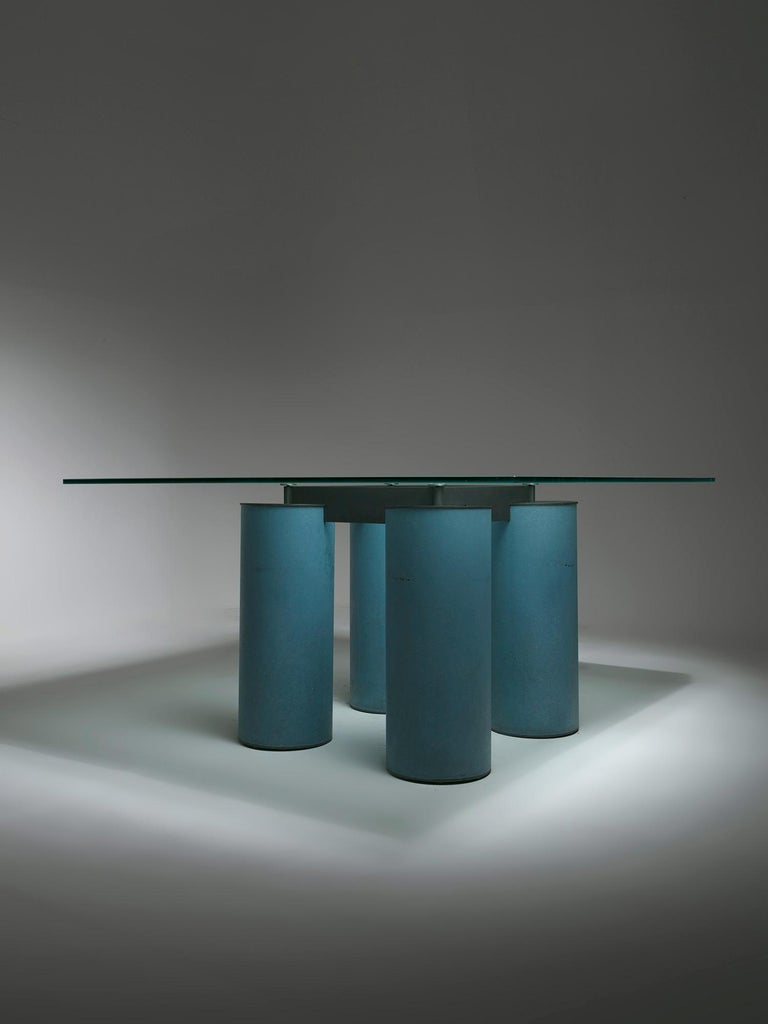Serenissimo table by Lella and Massimo Vignelli for Acerbis.
Four metal columns with venetian stucco finish support a large glass top.
 