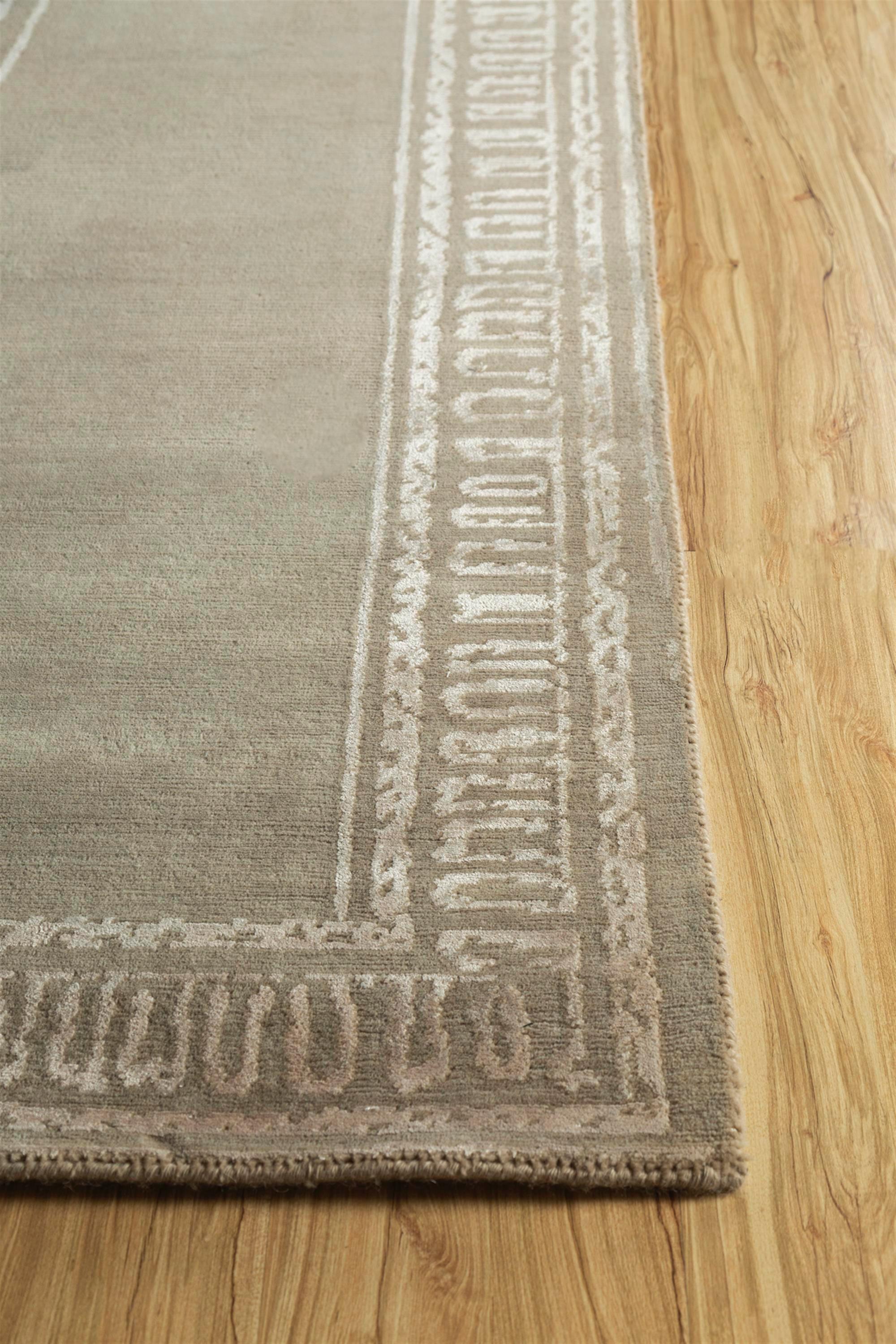 Can a rug transform a room? Discover the answer with this modern, hand-knotted masterpiece . Immerse your space in its soothing tone-on-tone palette, instantly uplifting the mood. With a ground color of Mink and a border in Medium Tan, this rug