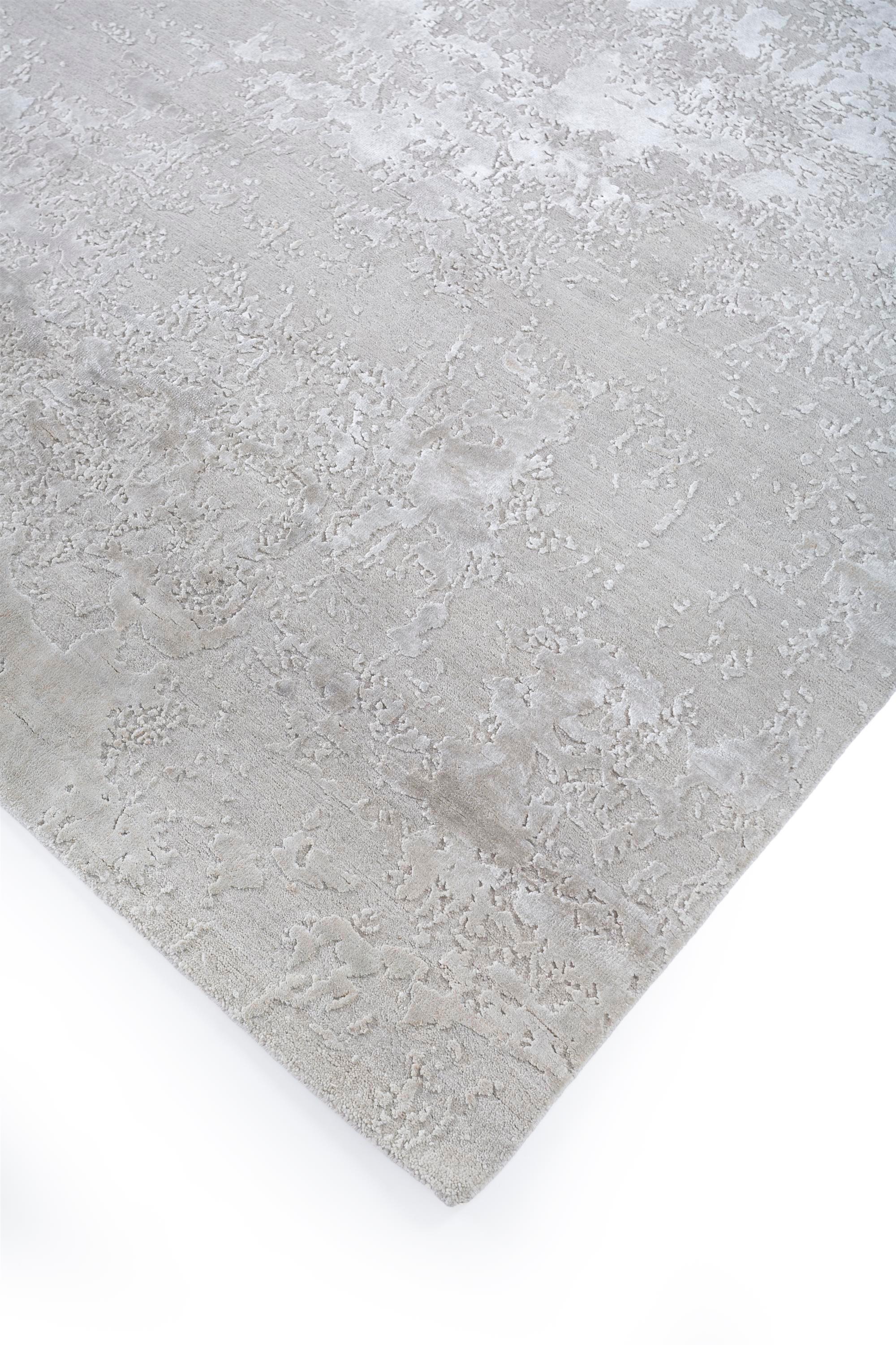 A harmonious blend of nature and technology in a muted color palette of ivory and flask! This hand-knotted rug artfully captures the beauty of imperfections, seamlessly incorporating misprints and nature's subtle disruptions into its design.