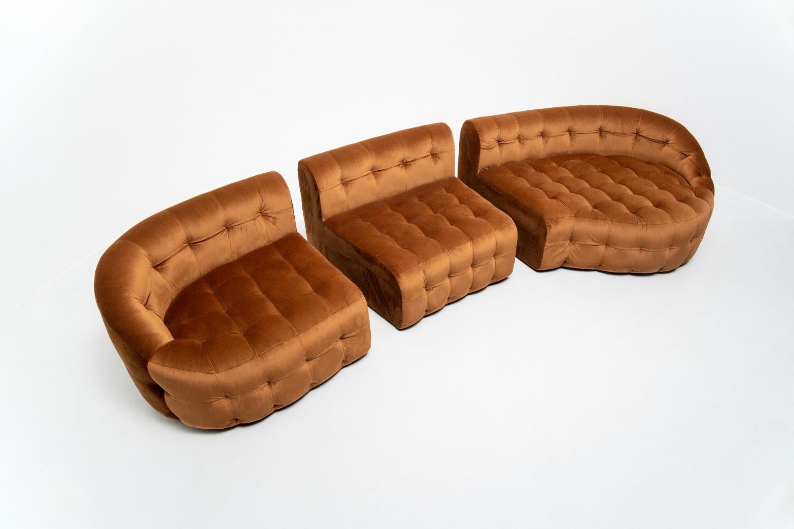 Serenity sofa tan, a tufted modular sofa with modules 1A, 4 and 2B adds glamour to interior spaces. It has a unique versatility of shape and size enhanced by rich velvet. Each module can be sold separately and combined with others to create a unique