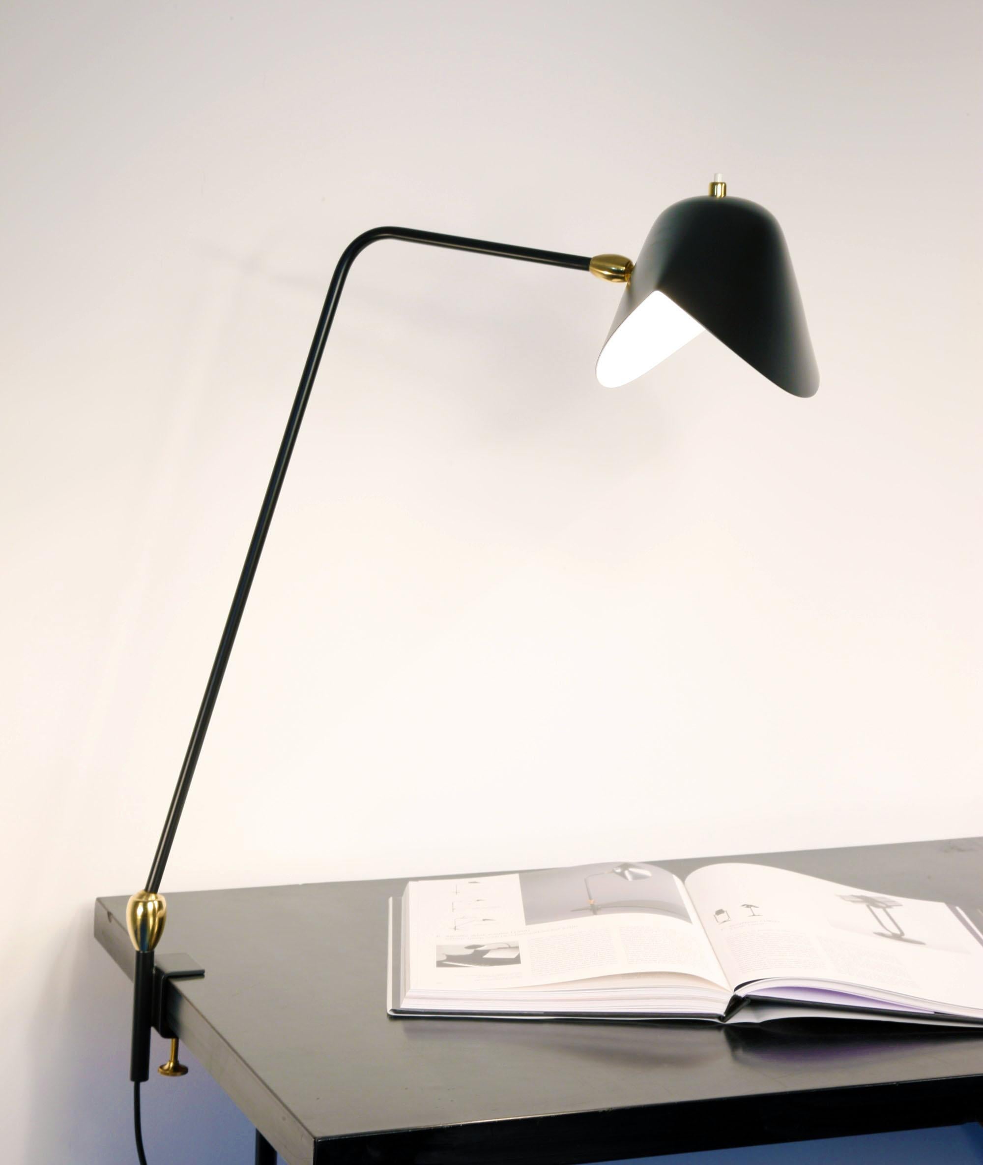 36 inches at its highest, this adjustable lamp may affix to many surfaces providing direct lighting where it is needed.

Available in white or black. Brass swivels connect the shades.

Color option
Available in black or