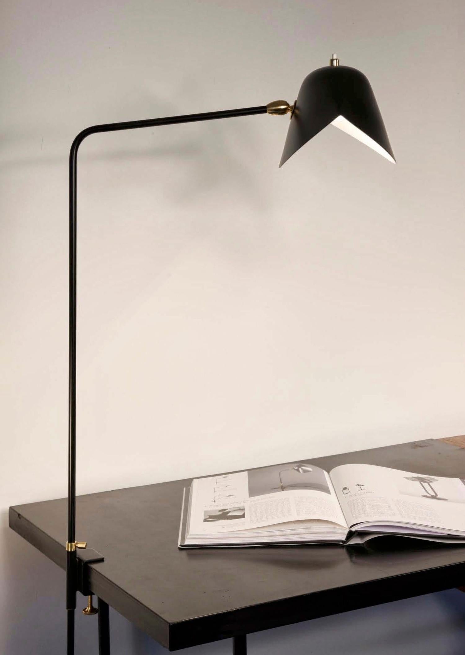 Clamp desk lamp. At 26 inches at its highest, this lamp may affix to many surfaces providing direct lighting where it is needed.

Available in white or black. Brass swivels connect the shades.

CUSTOMIZATION
Customization of the clamping