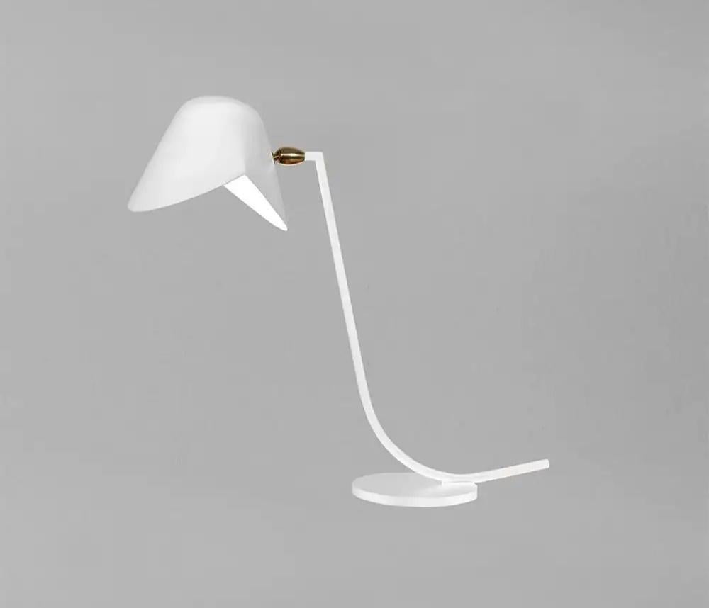 Unique for the Antony Desk lamp, Serge Mouille designed a sloping arm with an angled top attaching to the shade. All atop a round base.

Brass swivel connects the shade. Available in white or black

COLOR OPTION
Available in Black or