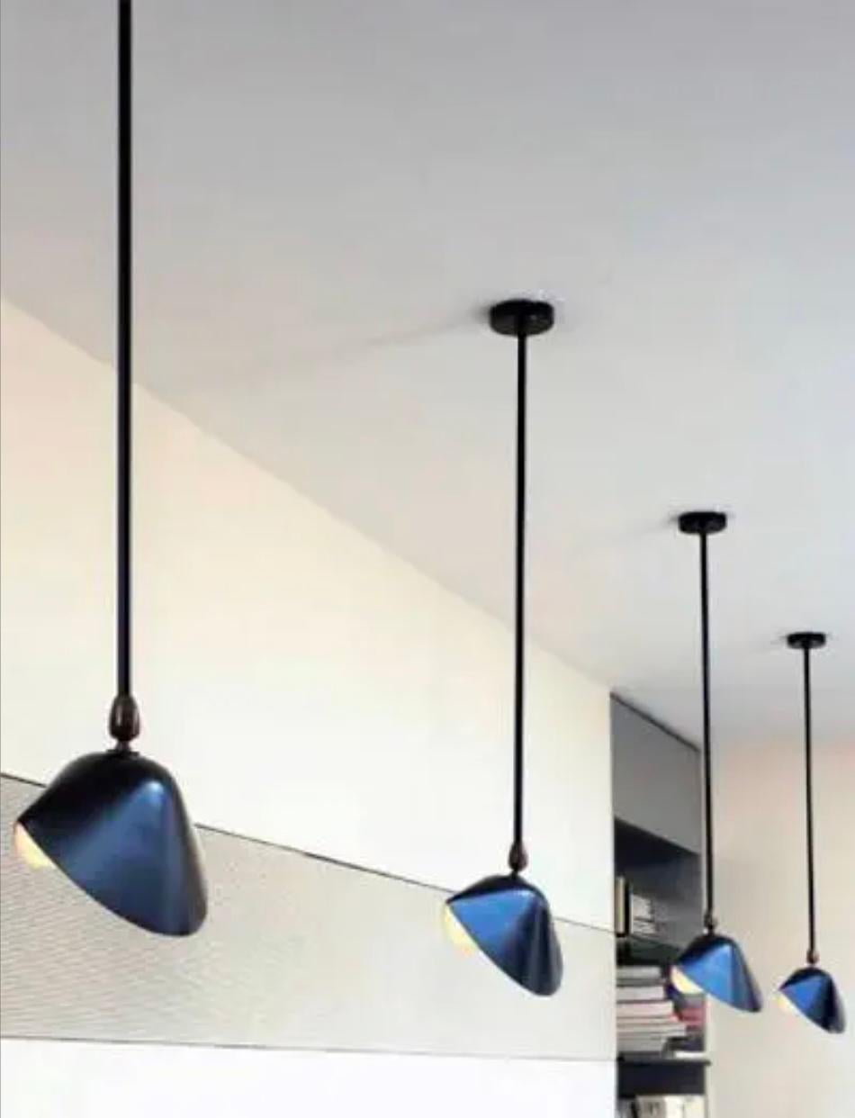 Serge Mouille 'Bibliothèque' ceiling lamp in black.

Originally designed in 1953, this iconic pendant lamp is still made by Edition Serge Mouille in France using many of the same small-scale manufacturing techniques and scrupulous attention to