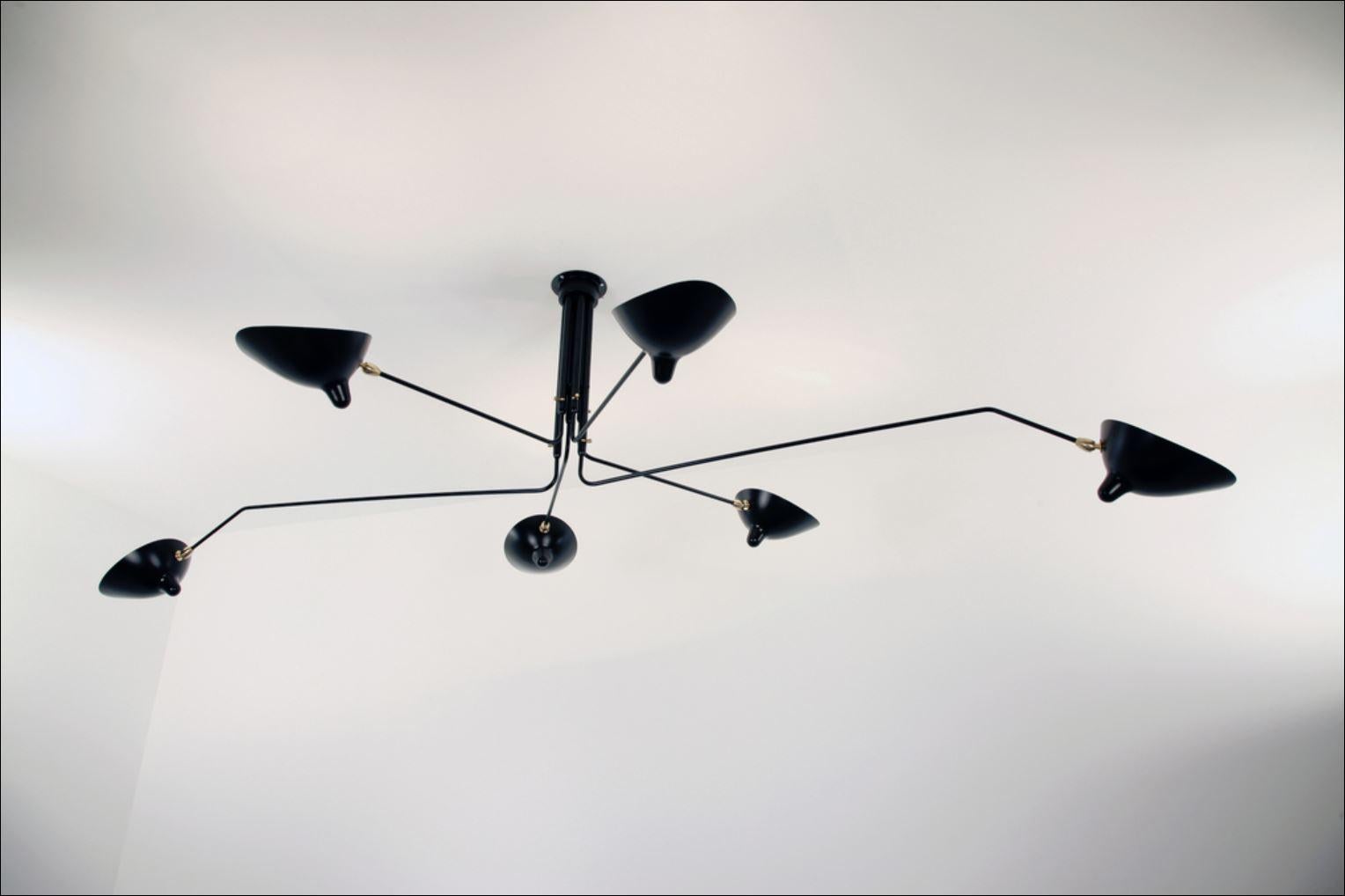 Impressively large, this six arm ceiling lamp is a Mouille classic. Tilting and rotating heads with rotating arms of 31 and 54 inches make this fixture a truly spectacular statement in a large room.

Brass swivels connect the shades. The arms have