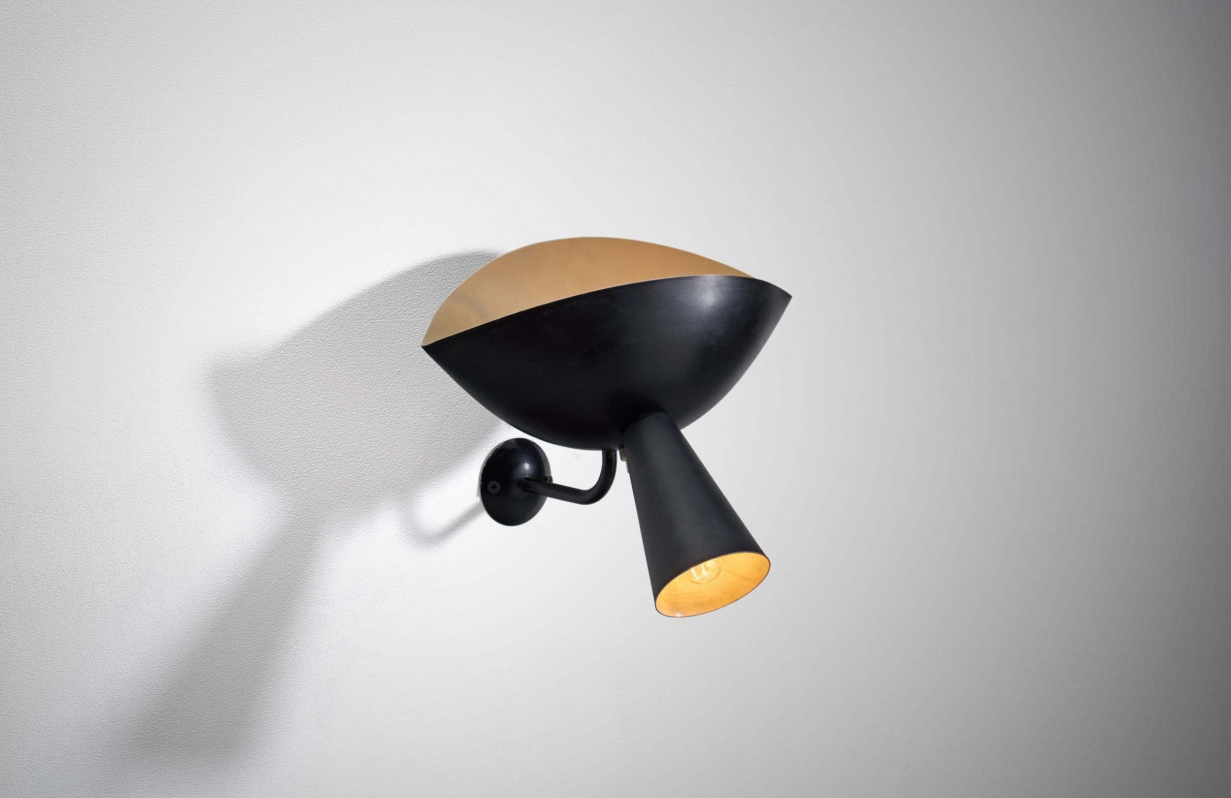 This lamp is an original from the 1950s and not one of the many later reproductions. The Cachan wall sconce comprises both an upper sphere, which casts an ambient glow, and a cone-shaped task light. One 